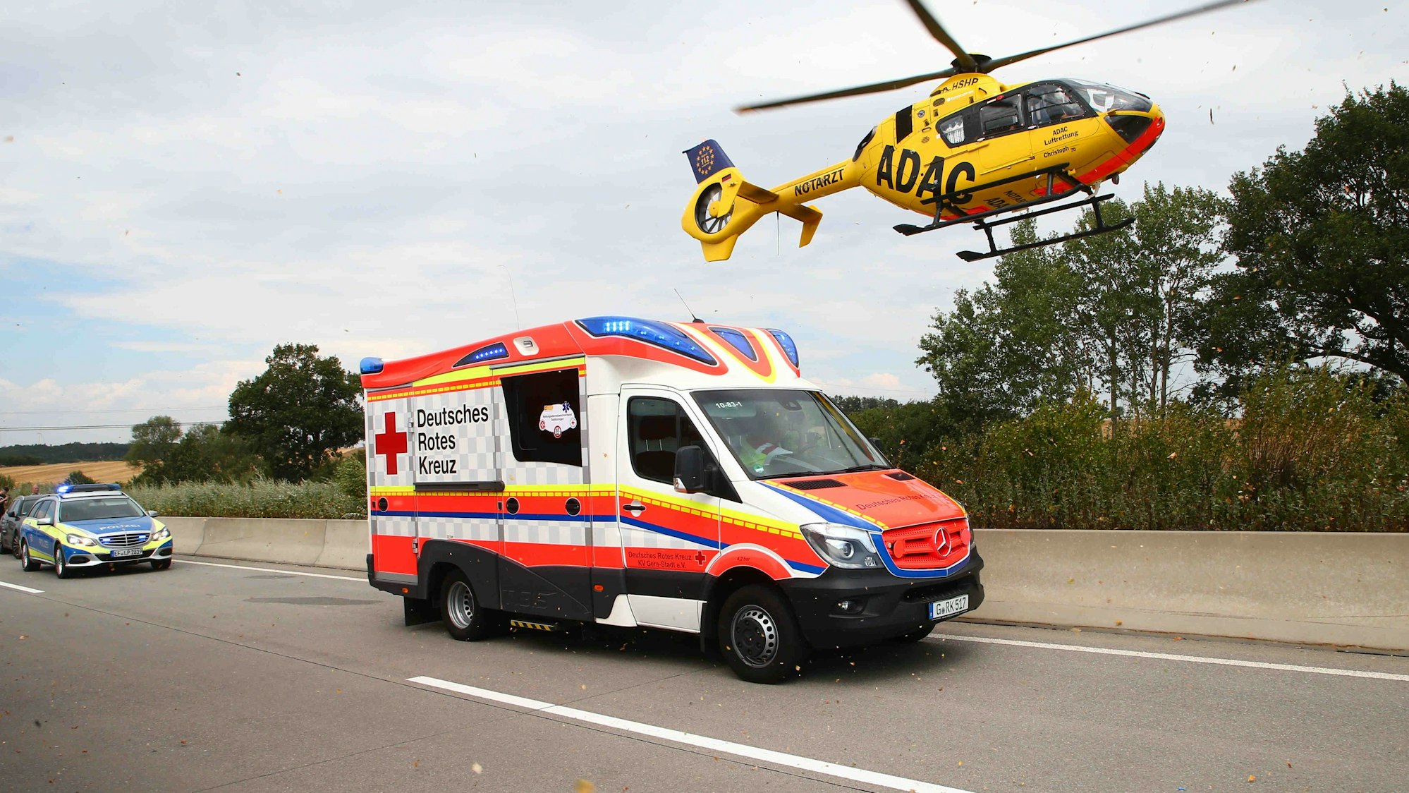 Rettungsfahrzeuge und ein Rettungshubschrauber sind auf der Autobahn im Einsatz