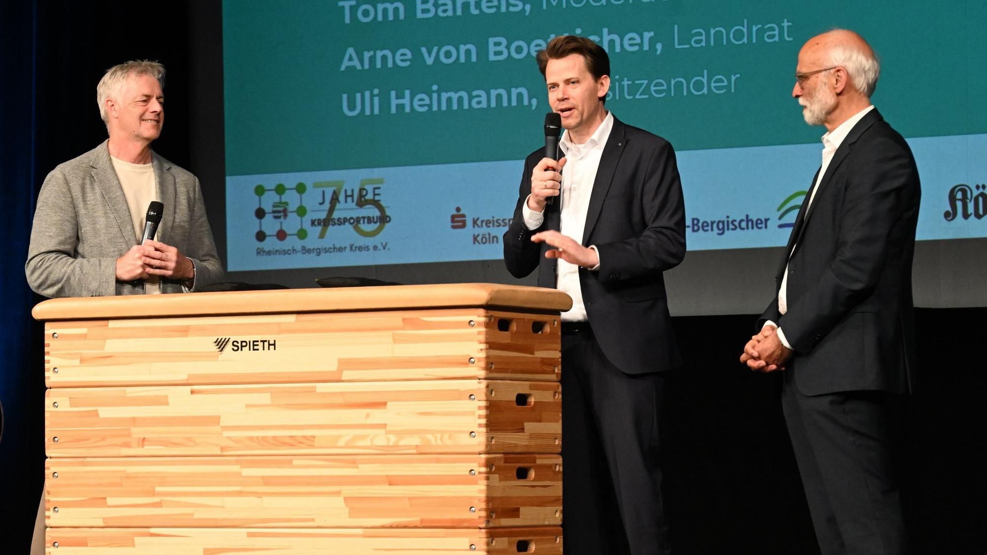 ARD-Sportmoderator Tom Bartels spricht mit Landrat Arne von Boetticher und Kreissportbundchef Uli Heimann.