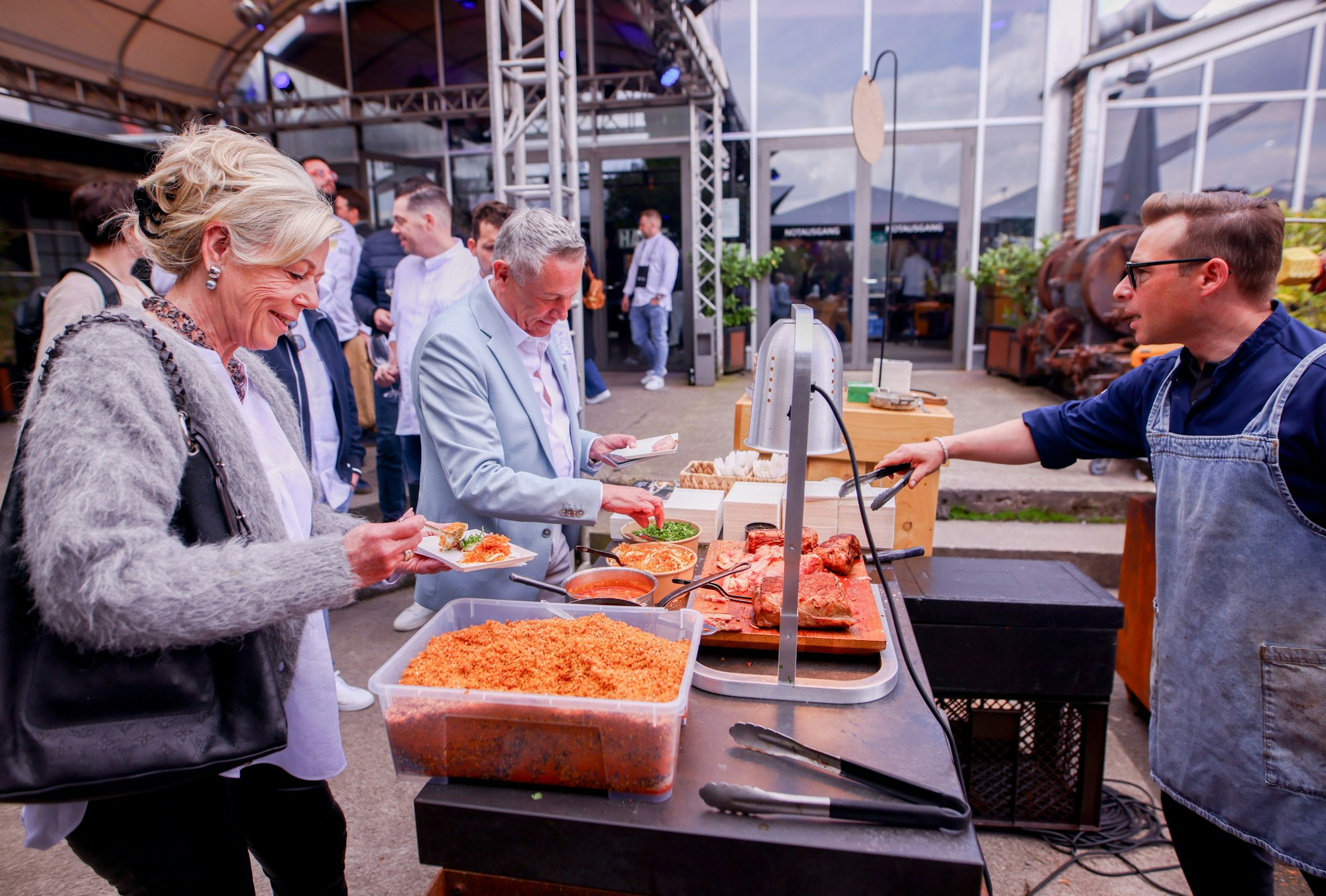 Das Ehepaar Schievelkamp bekommt eine Portion geröstetes Kalb auf asiatische Art vom Leipziger Koch Nils Jorra.