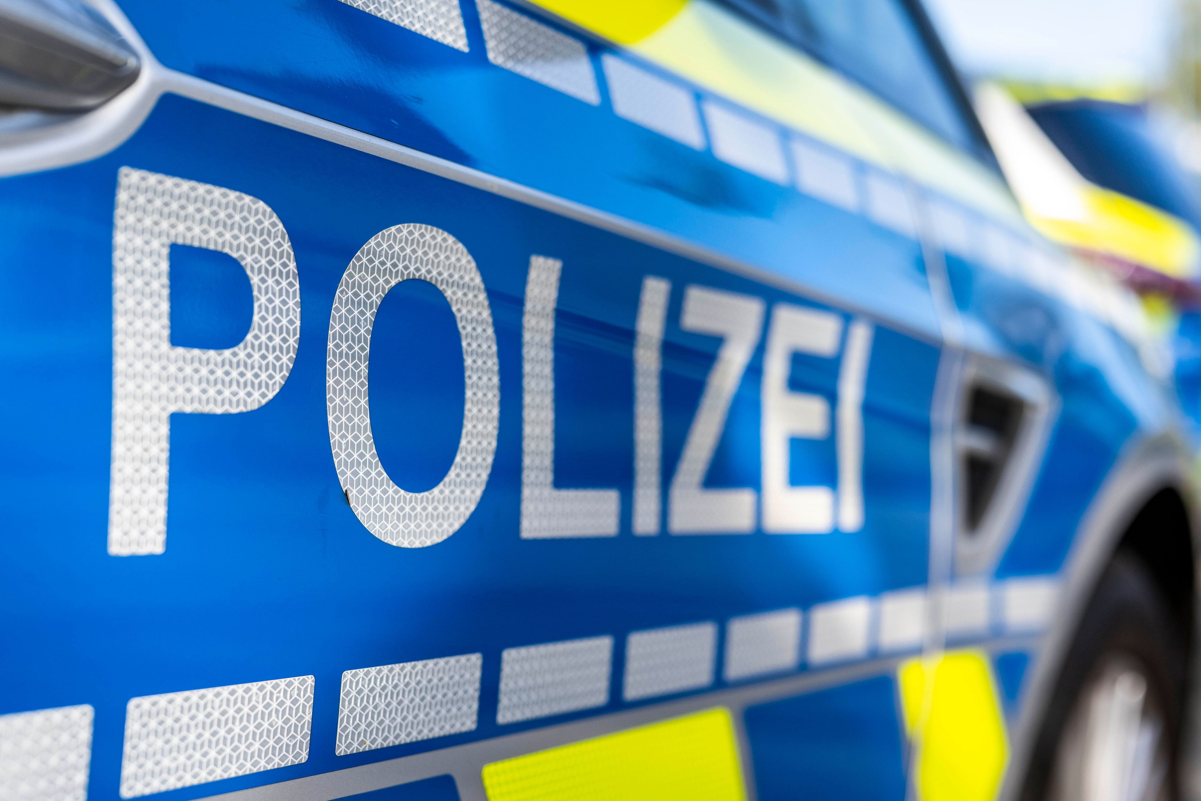 ILLUSTRATION - 28.09.2021, Nordrhein-Westfalen, Gütersloh: An der Tür von einem Streifenwagen steht der Schriftzug «Polizei». Ein Unbekannter soll einen Gegenstand von einer Autobahnbrücke bei Regensburg auf ein darunter fahrendes Auto geworfen haben.  (zu dpa: «Gegenstand von Brücke auf Auto geworfen – Scheibe zerbricht») Foto: David Inderlied/dpa +++ dpa-Bildfunk +++