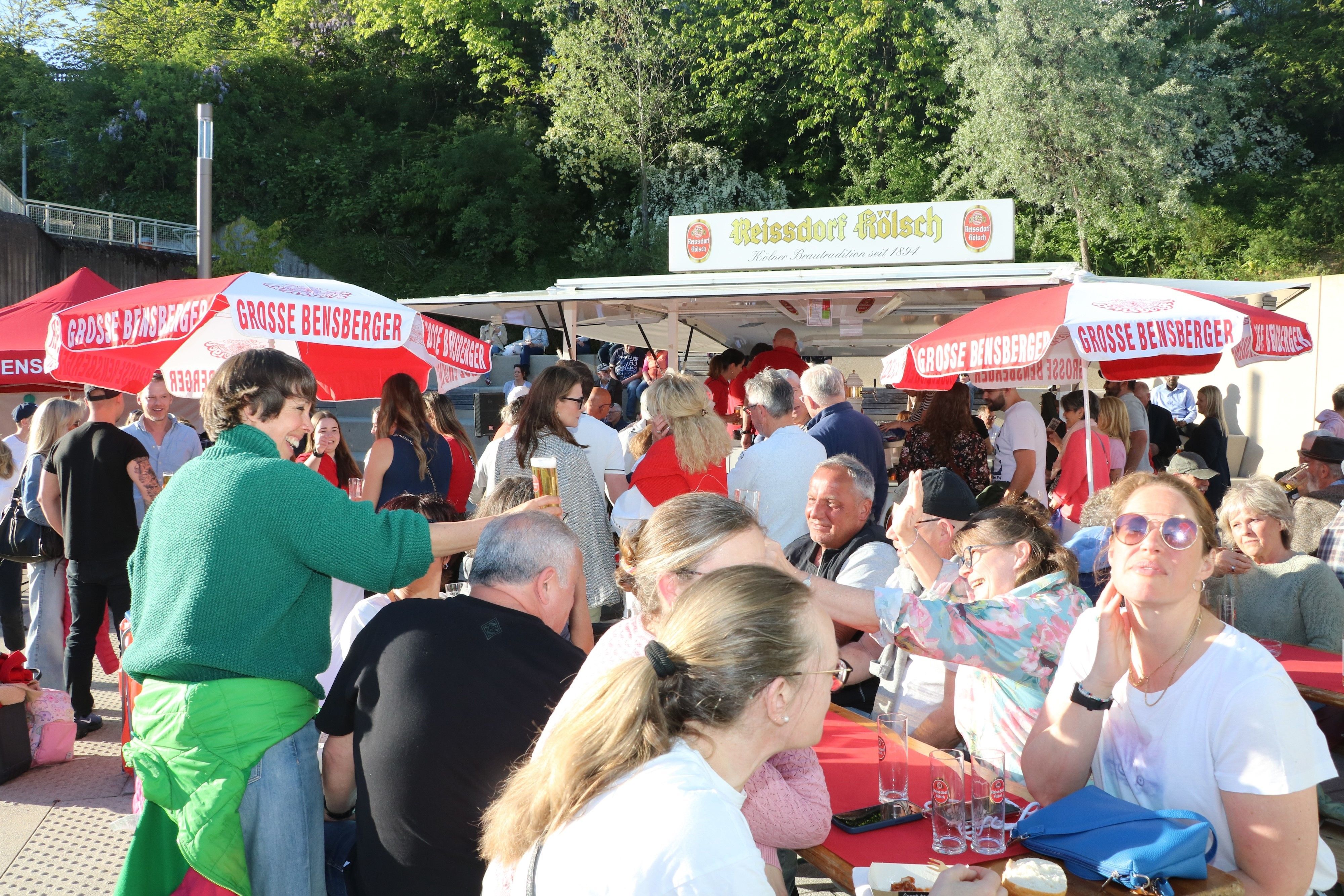 Menschen an Biertischen in der Sonne
