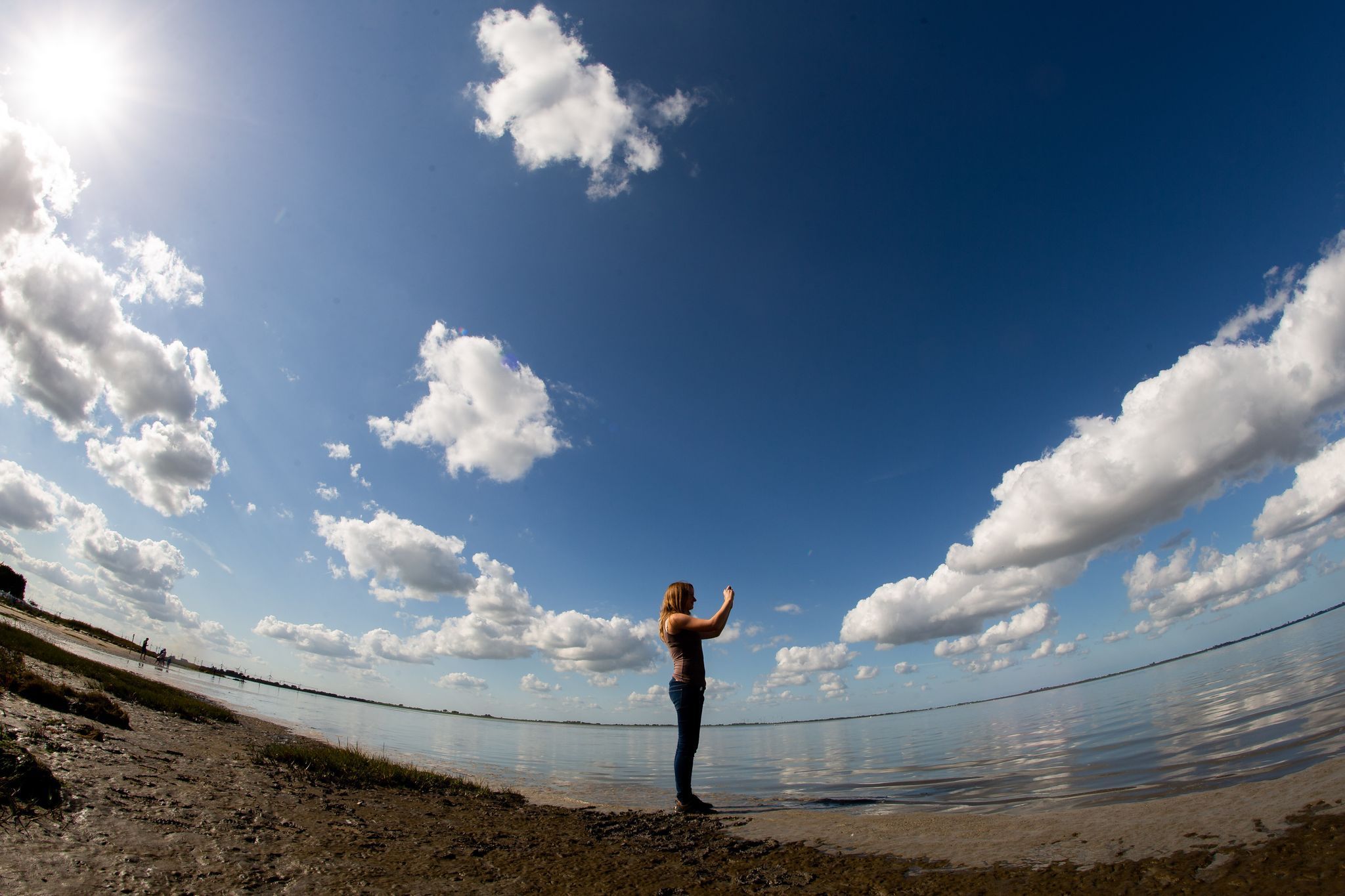Frau fotografiert mit einem Smartphone die Landschaft