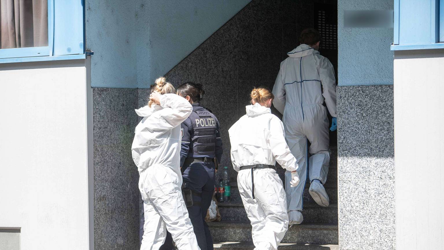 Beamte der Spurensicherung sind am Samstag (9. Mai) vor einem Mehrfamilienhaus in Köln-Ehrenfeld im Einsatz.
