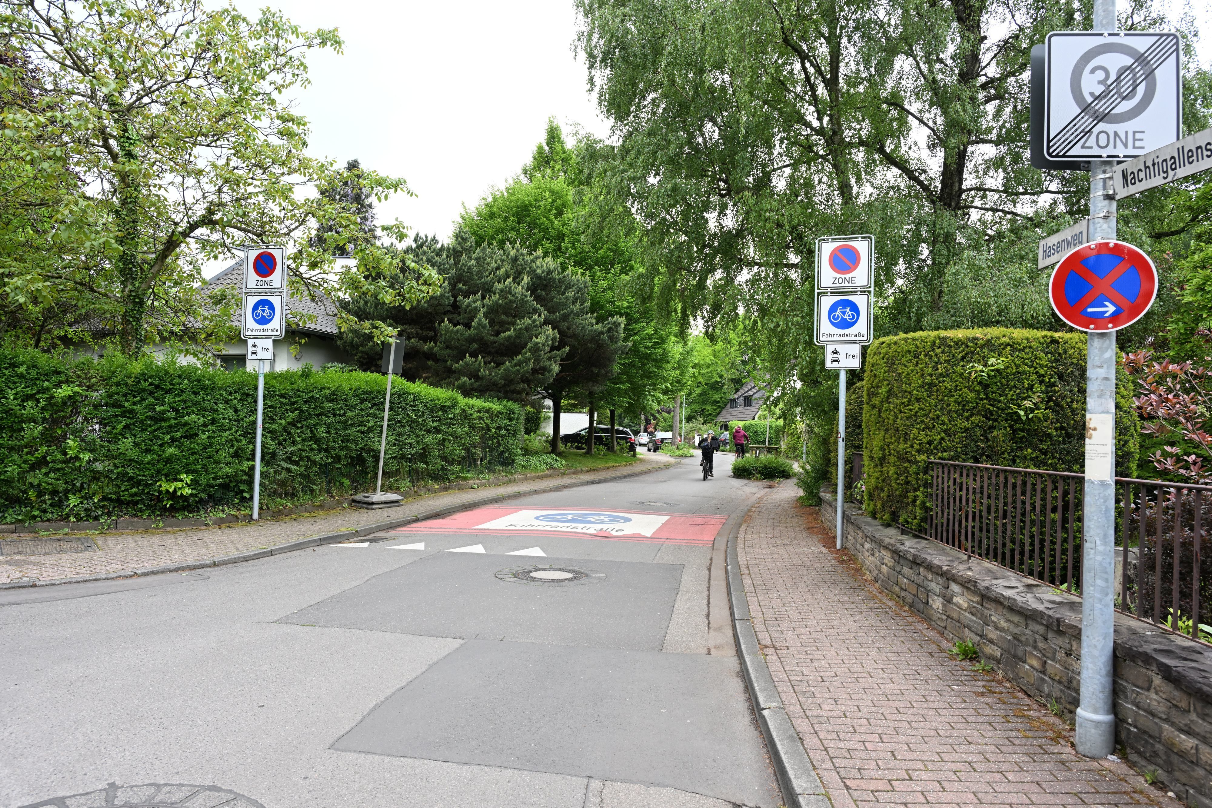 Rechts und links der Fahrbahn stehen Verkehrsschilder.