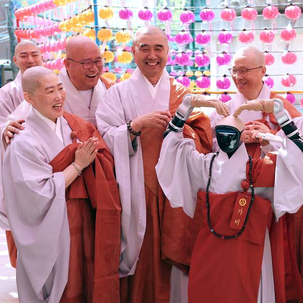 Gabi (C), a humanoid robot dressed as a Buddhist monk, poses with Buddhist monks as it attends an ordination ceremony as part of celebrations for the upcoming Buddha's birthday at Jogye Temple in Seoul on May 6, 2026.