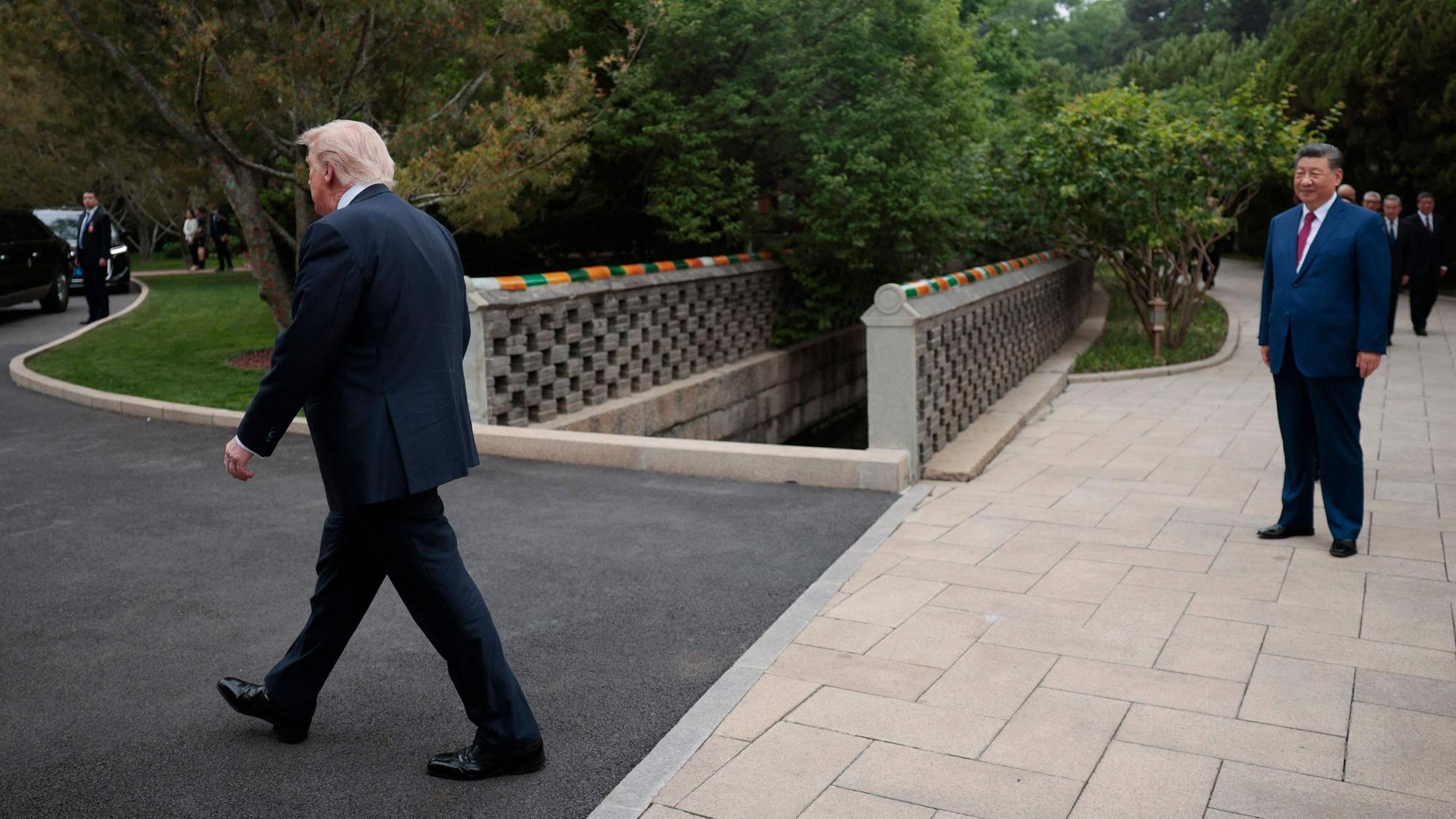 TOPSHOT - US President Donald Trump (L) walks towards his car as Chinas President Xi Jinping (R) watches following a visit to Zhongnanhai Garden in Beijing on May 15, 2026. (Photo by Evan Vucci / POOL / AFP)