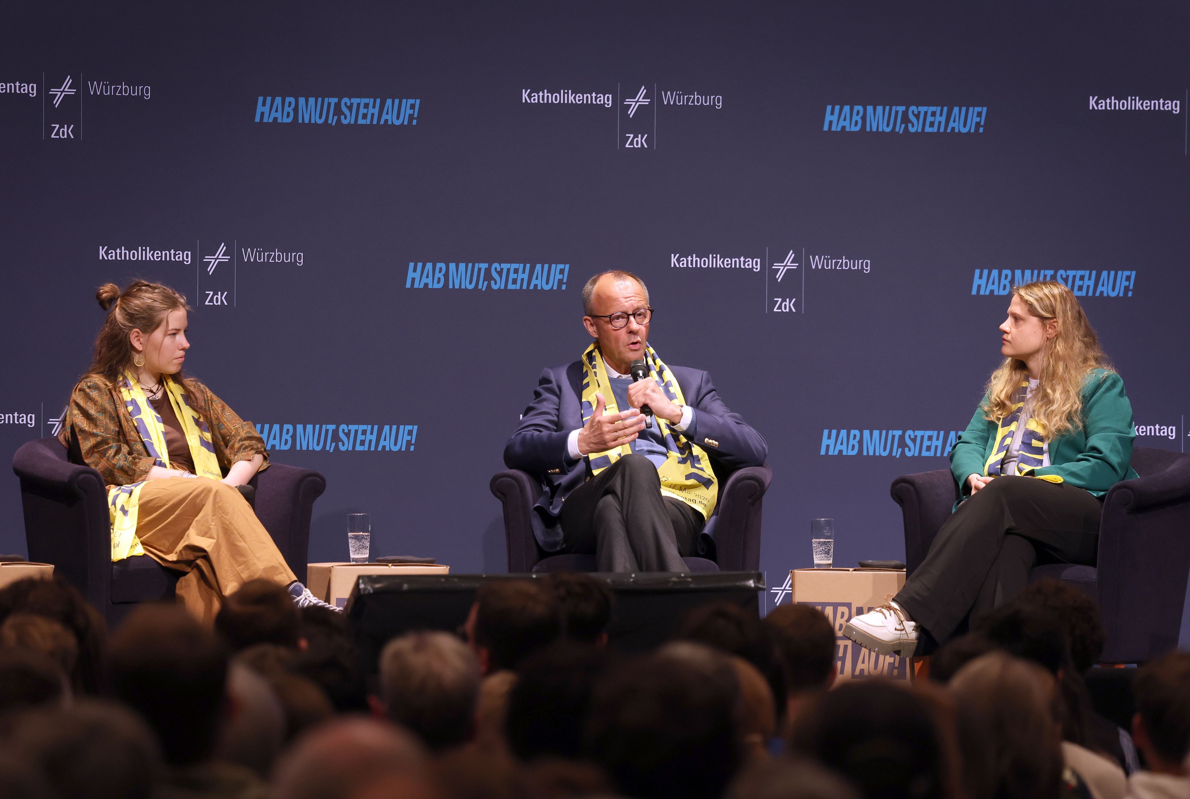 Amy Kirchhoff (l-r), Generalsekretärin der Bundesschülerkonferenz, Bundeskanzler Friedrich Merz (CDU) und Lisa Quarch, Geistliche Leiterin des Bundes der Deutschen Katholischen Jugend, nehmen beim 104. Deutschen Katholikentag an einer Podiumsdiskussion teil.