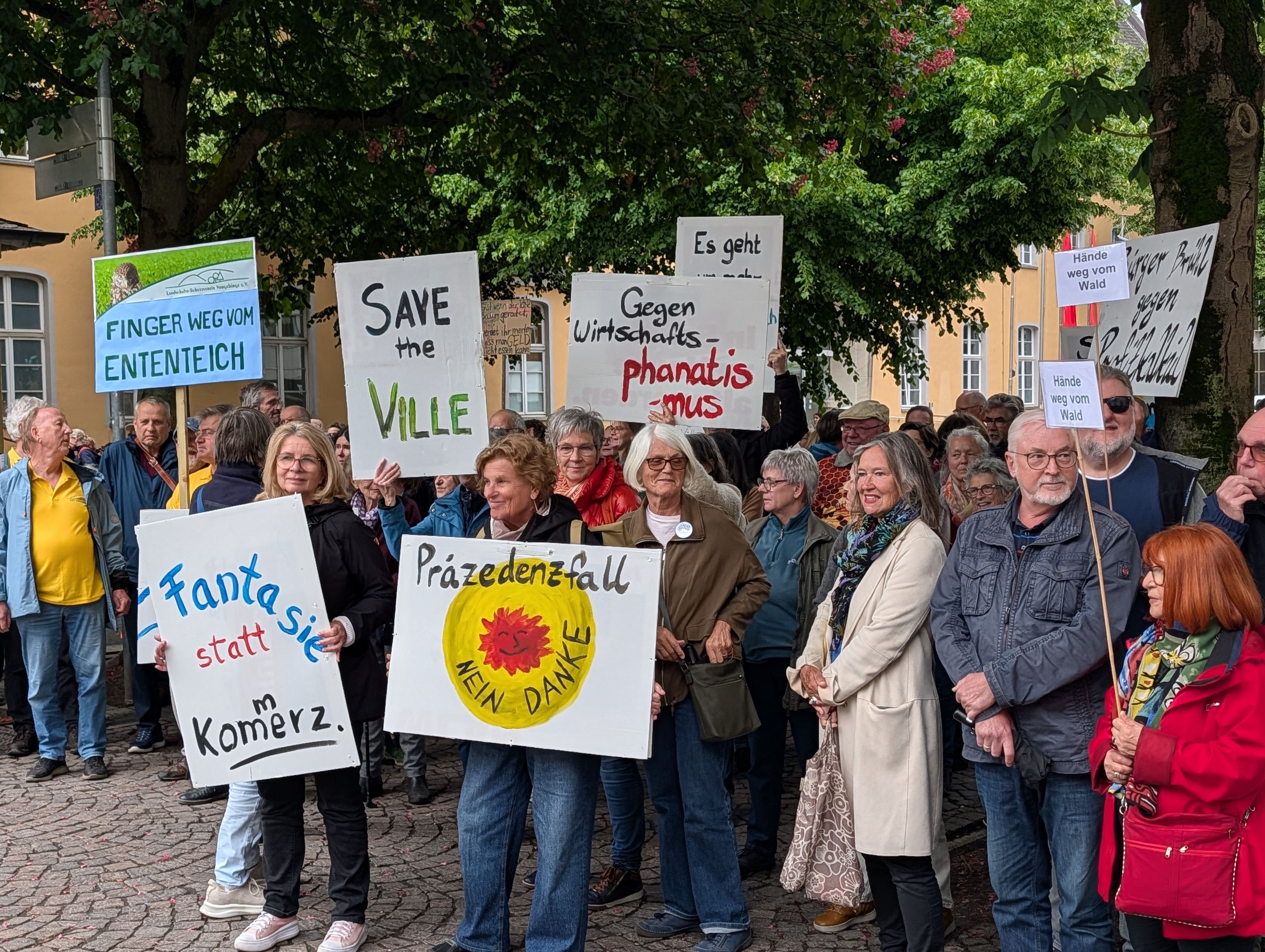 Das Foto zeigt Demonstranten mit Plakaten in der Brühler Innenstadt.
