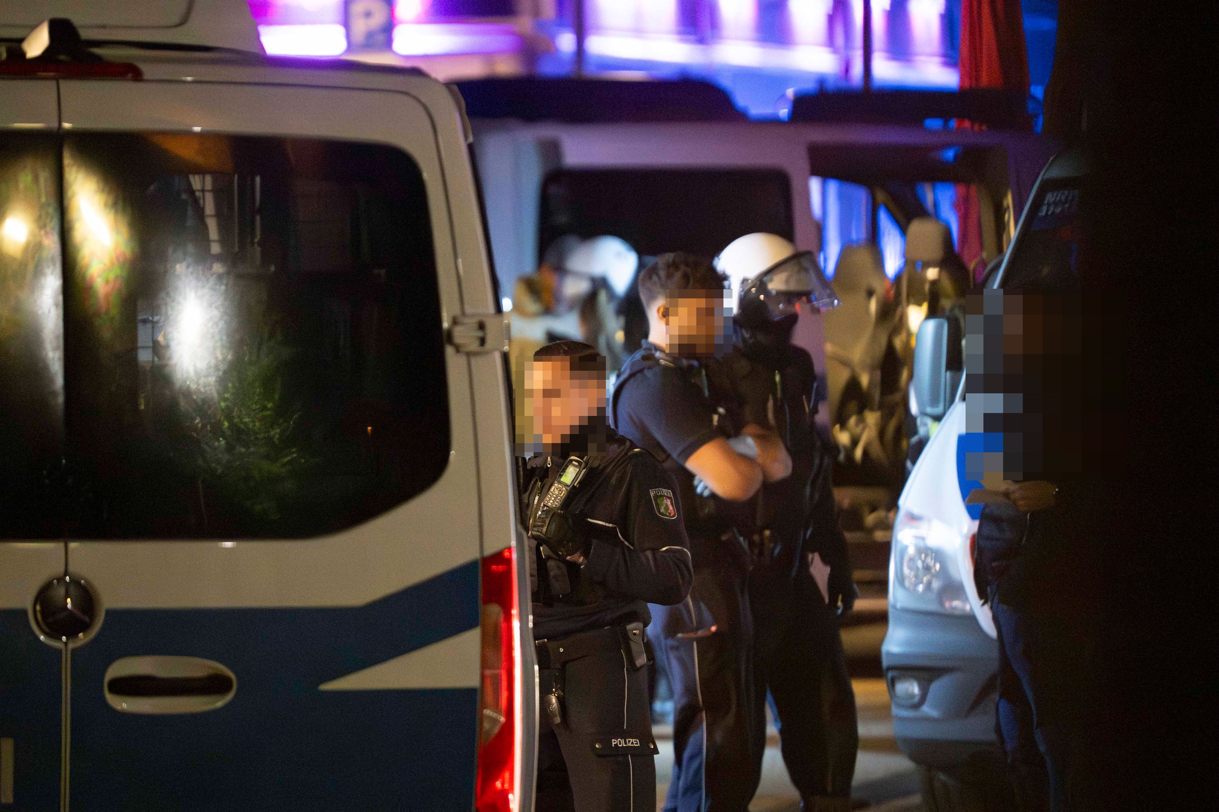 Das Bild zeigt Polizeibeamte, die mit einem mutmaßlichen Beteiligten der Schlägerei sprechen.