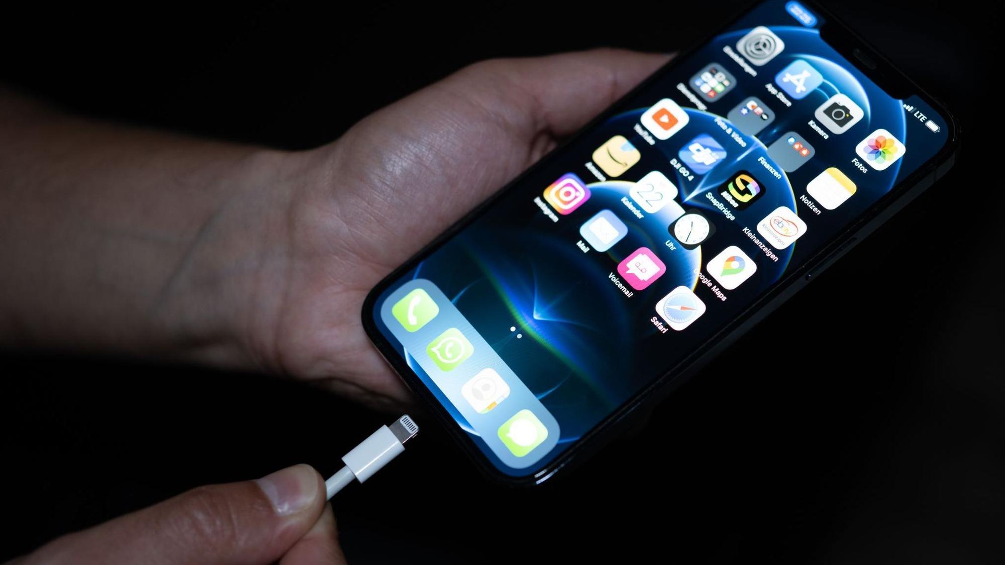 Eine Persin lädt ein Smartphone