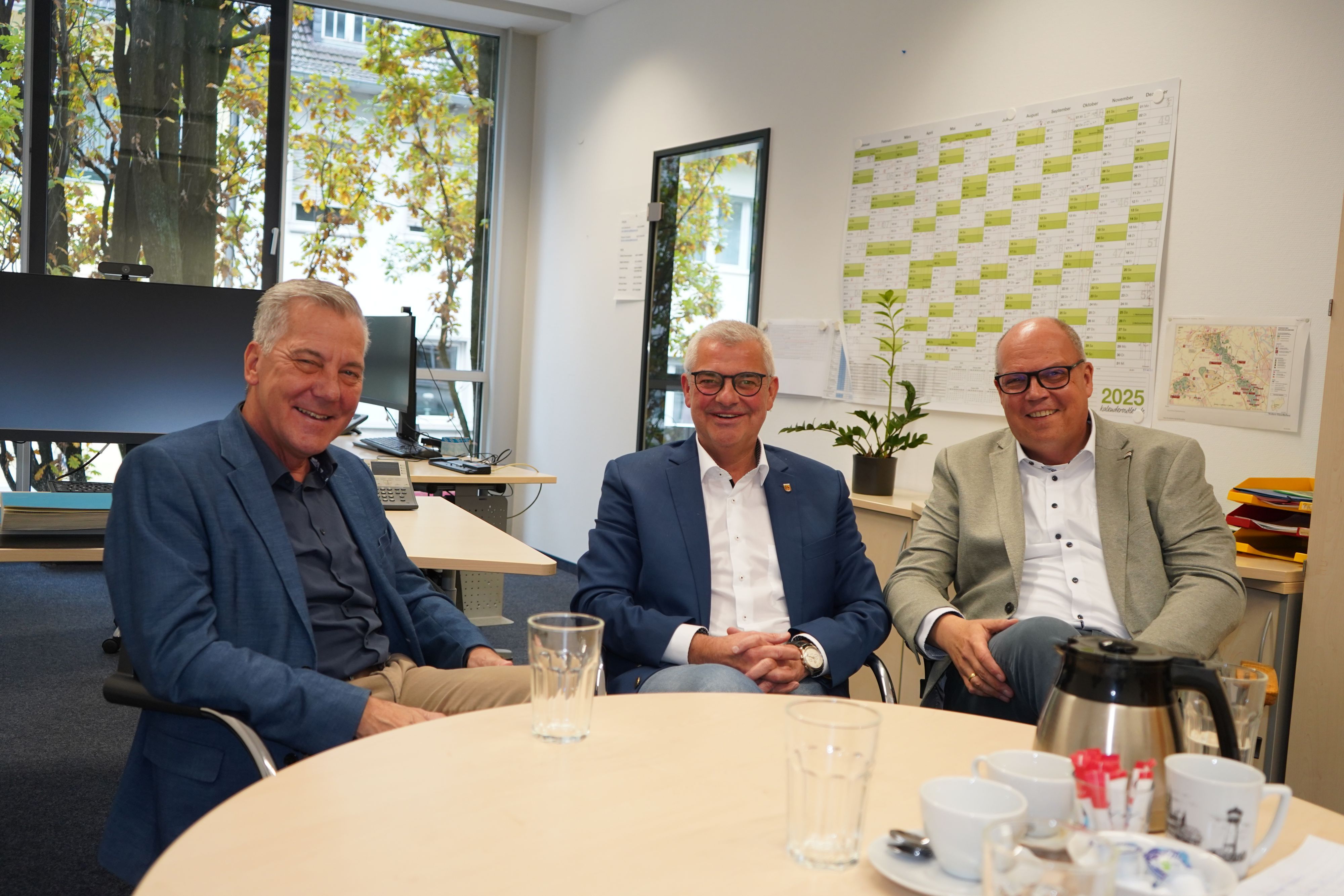 Auf dem Foto sind drei Männer zu sehen.