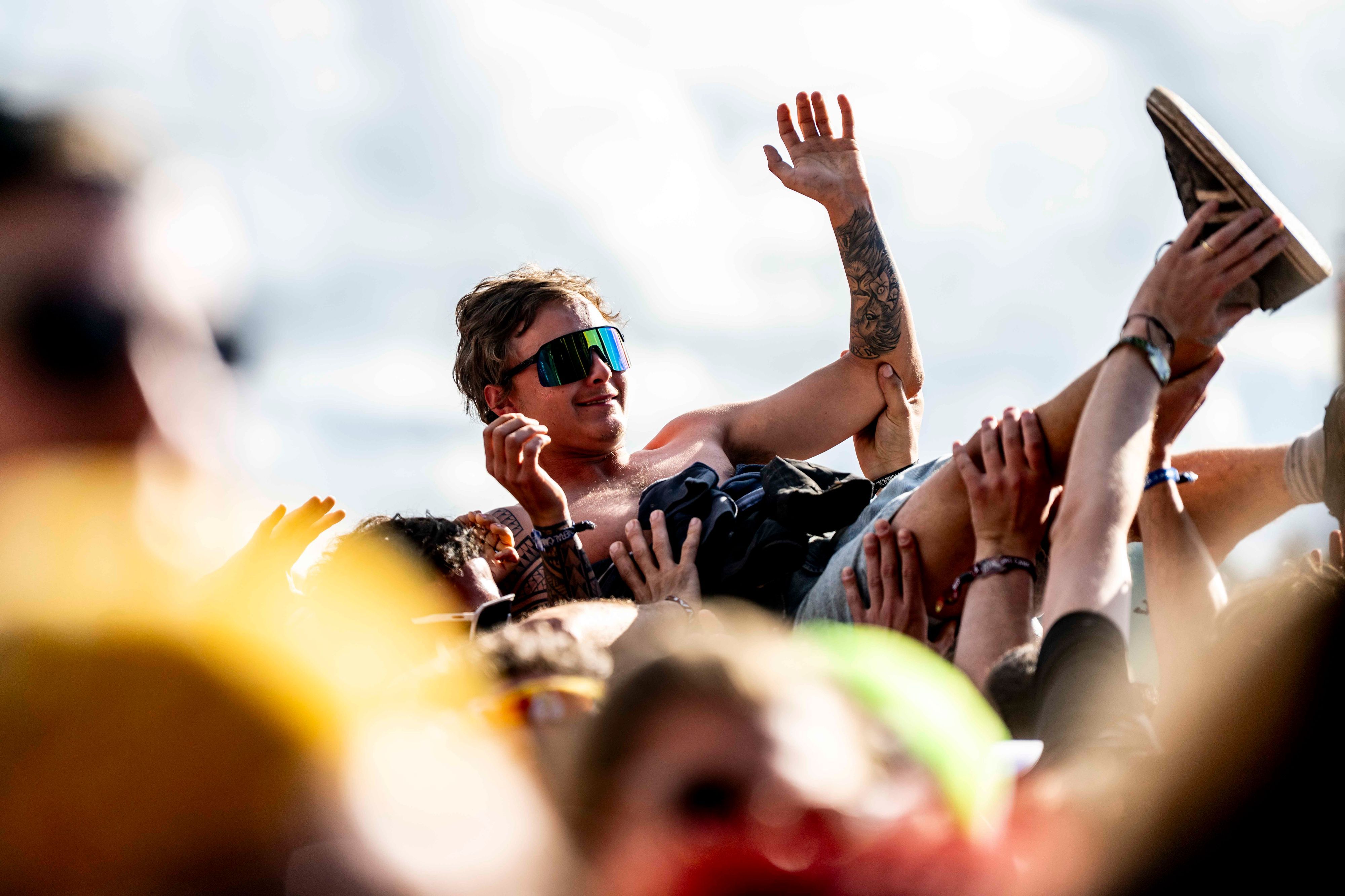 Beim Crowdsurfing wird ein Fan beim Festival Rock am Ring von anderen auf Händen über die Menge getragen.