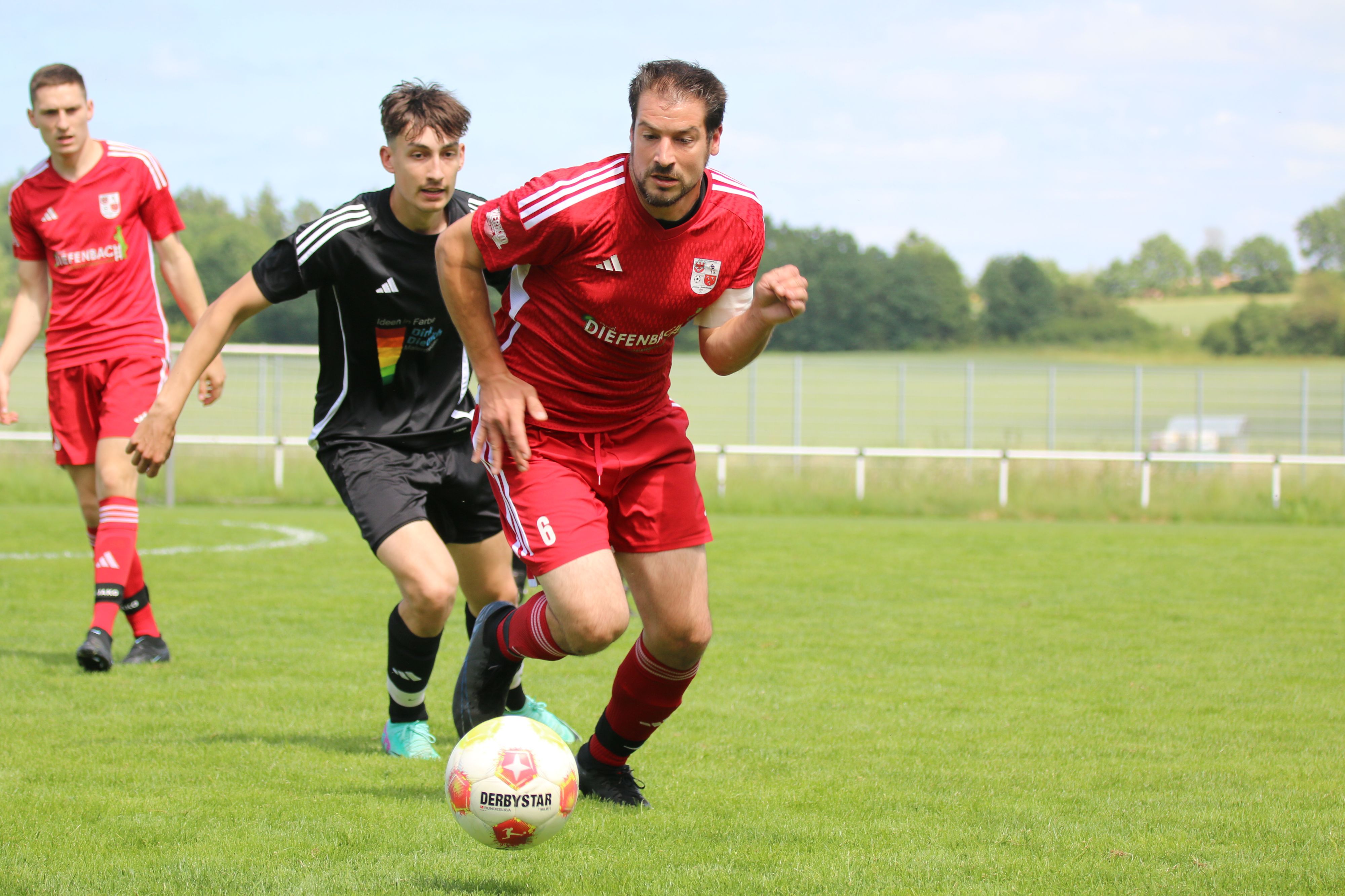 Dahlems Kapitän ist am Ball und wird von einem Gegenspieler verfolgt.
