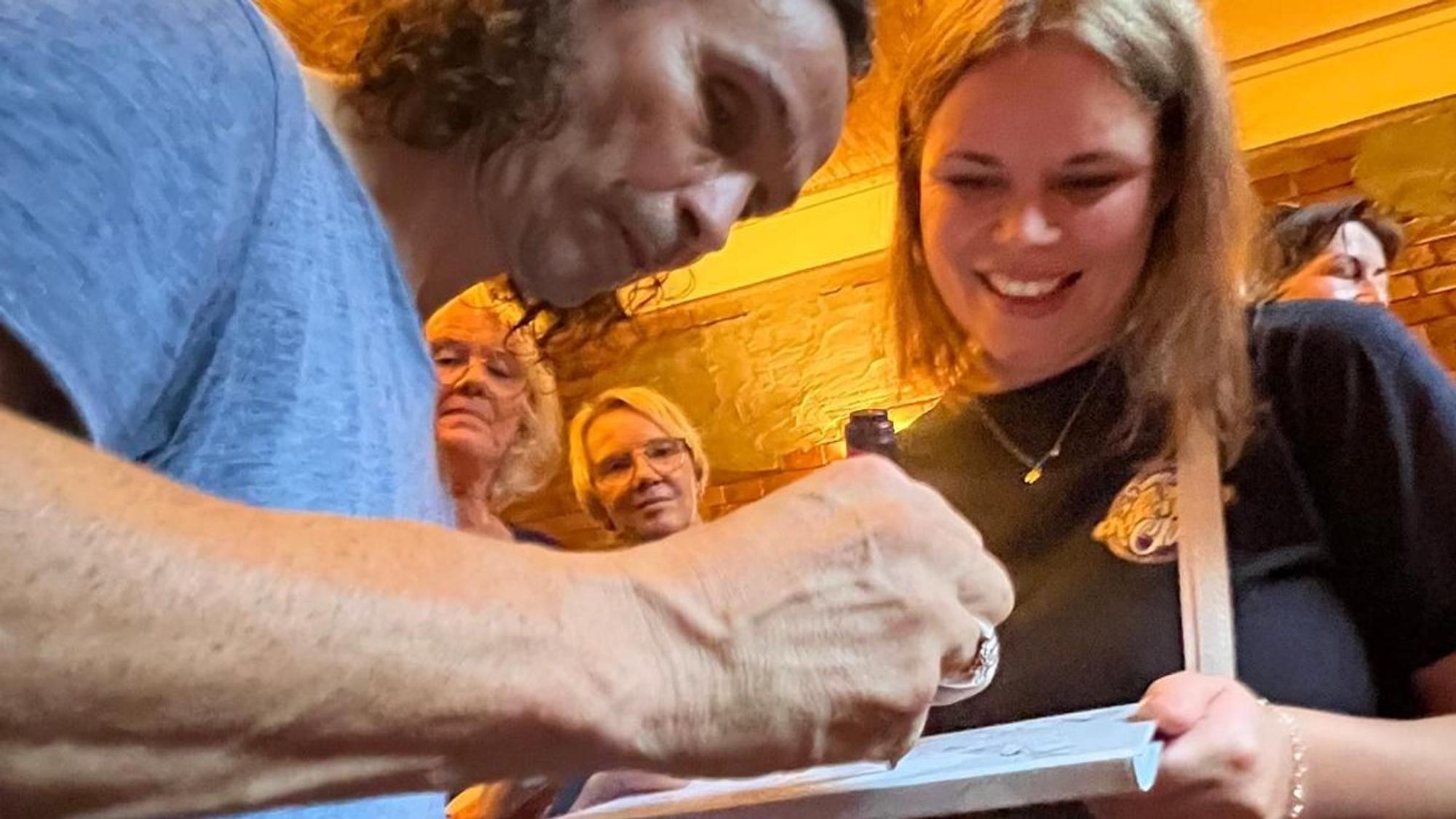 Stephan Brings gibt einer Sängerin ein Autogramm.