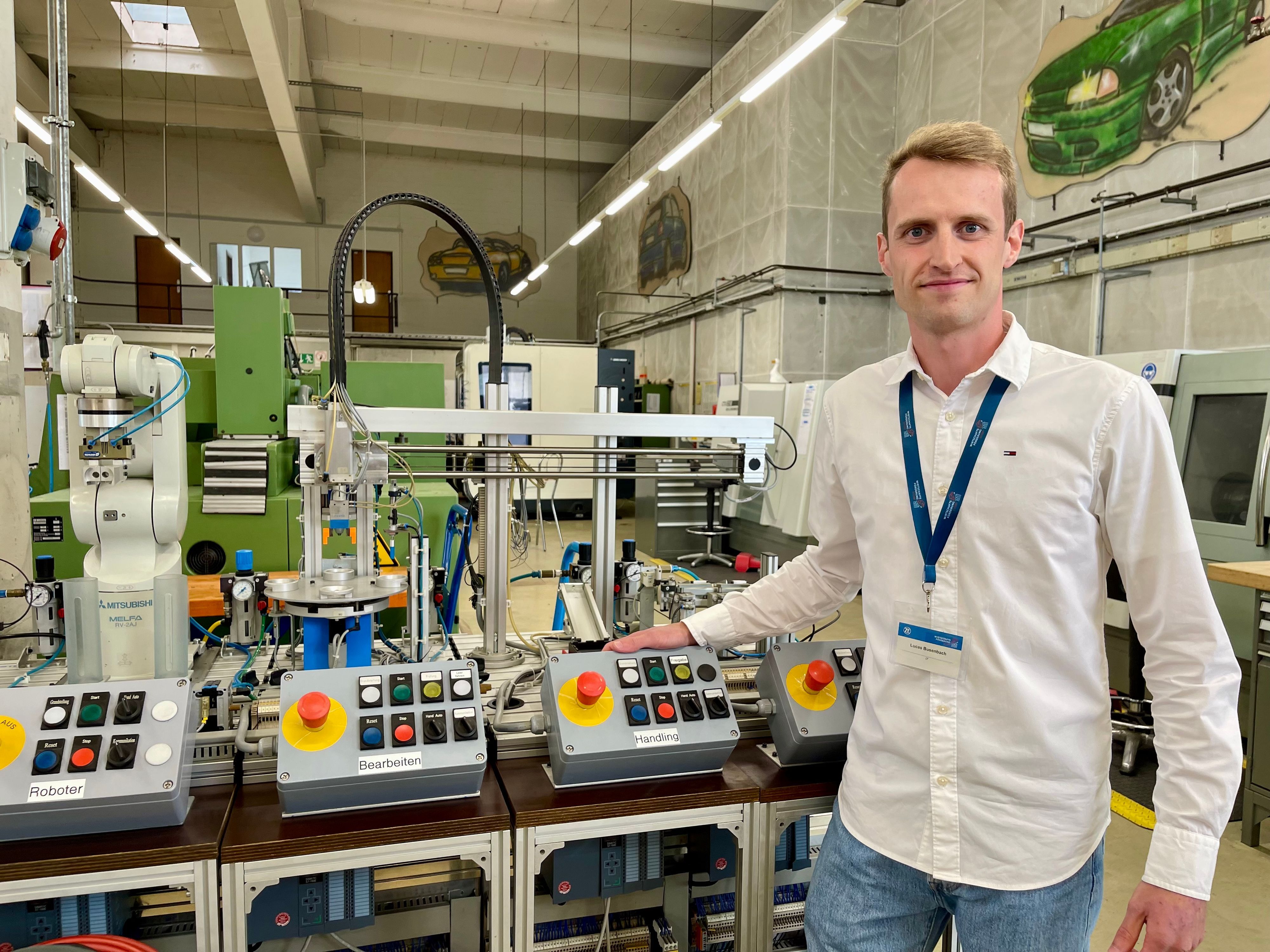 Ausbildungsleiter Lukas Biesenbach am Modulkaren Produktionssystem MPS, an dem Azubis unter anderem Steuerung und das Programmieren von Robotern lernen.