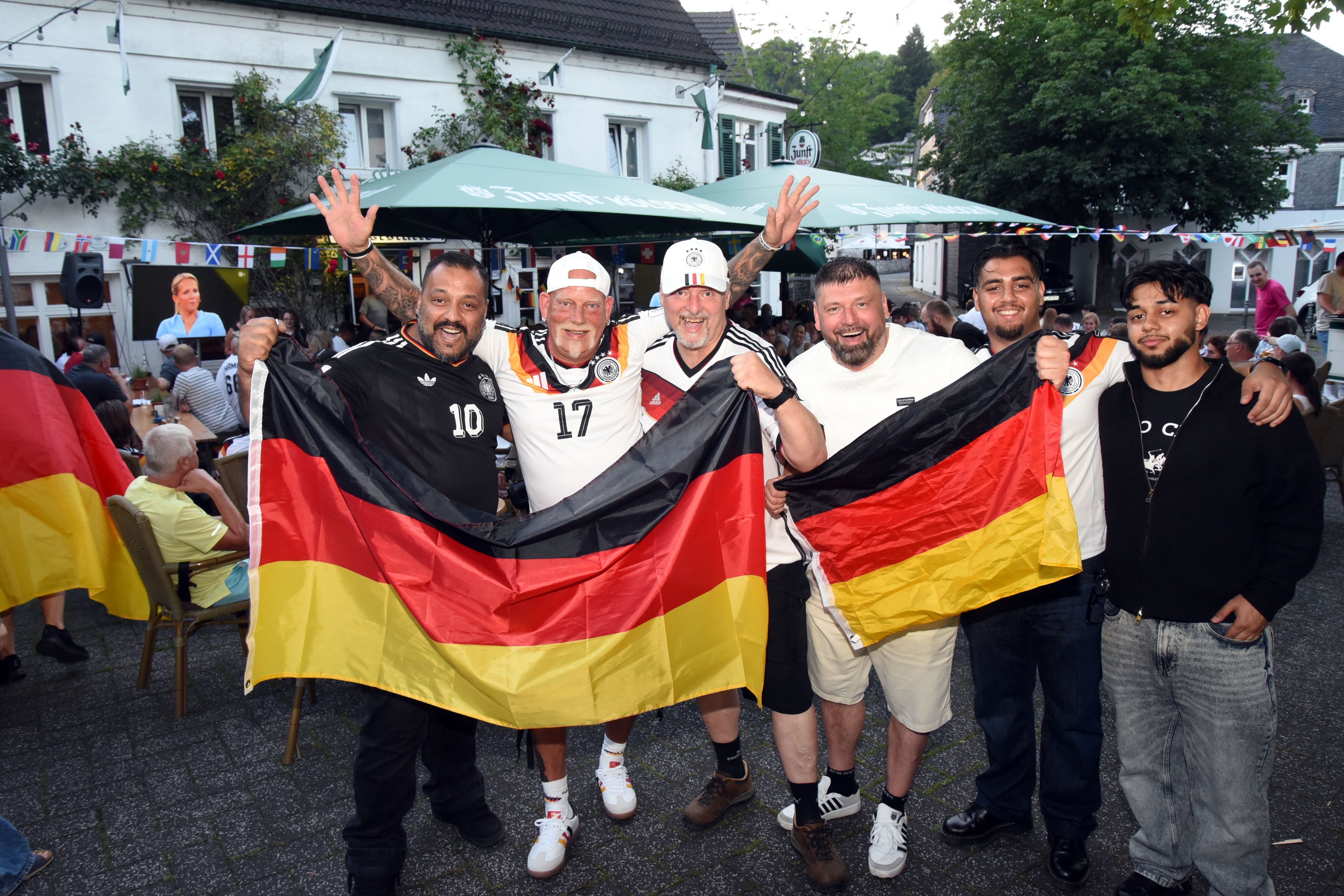 Mit Freunden sahen Osman Göhan (links) und Frank Lux (Zweiter von links) das Spiel gegen die Elfenbeinküste in der Gummersbacher Kultkneipe „Baumhof“.
