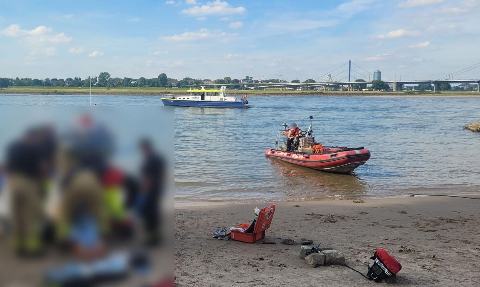 Rettungskräfte versorgen eine Person am Rheinufer in Düsseldorf.