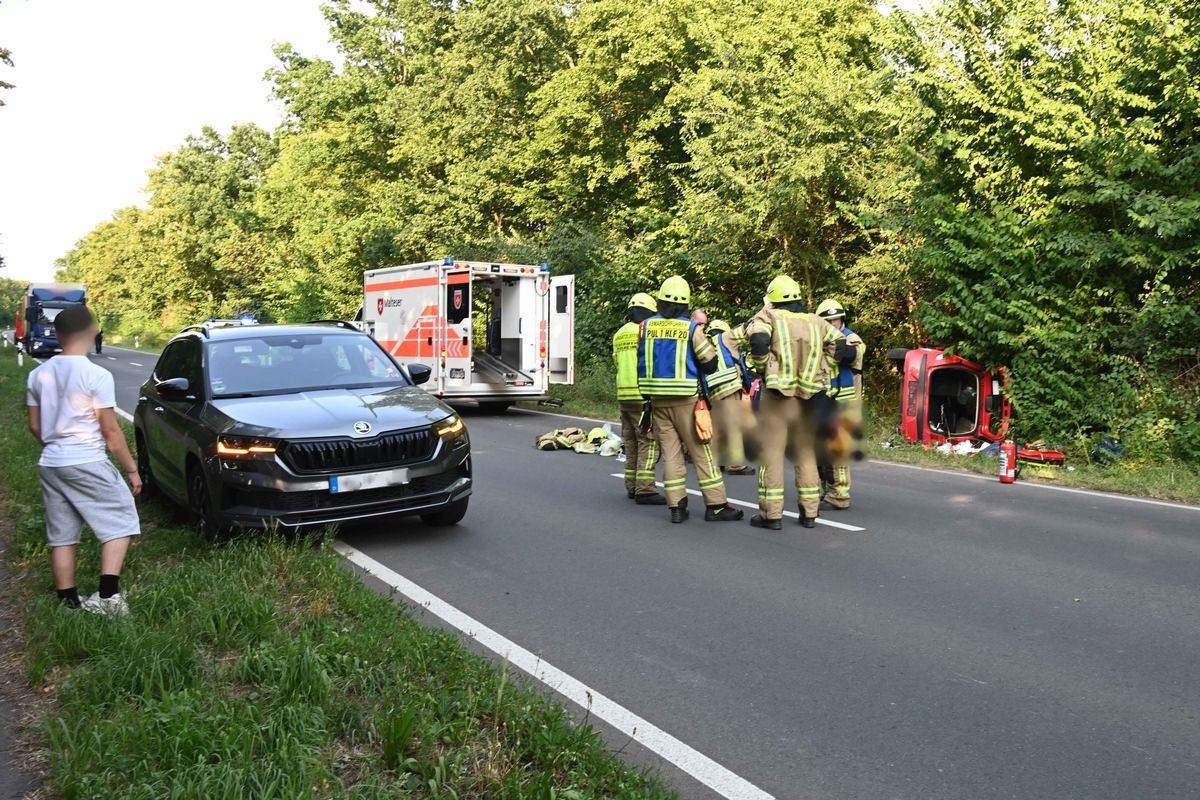Ein Kleinwagen liegt auf der Seite im Straßengraben.
