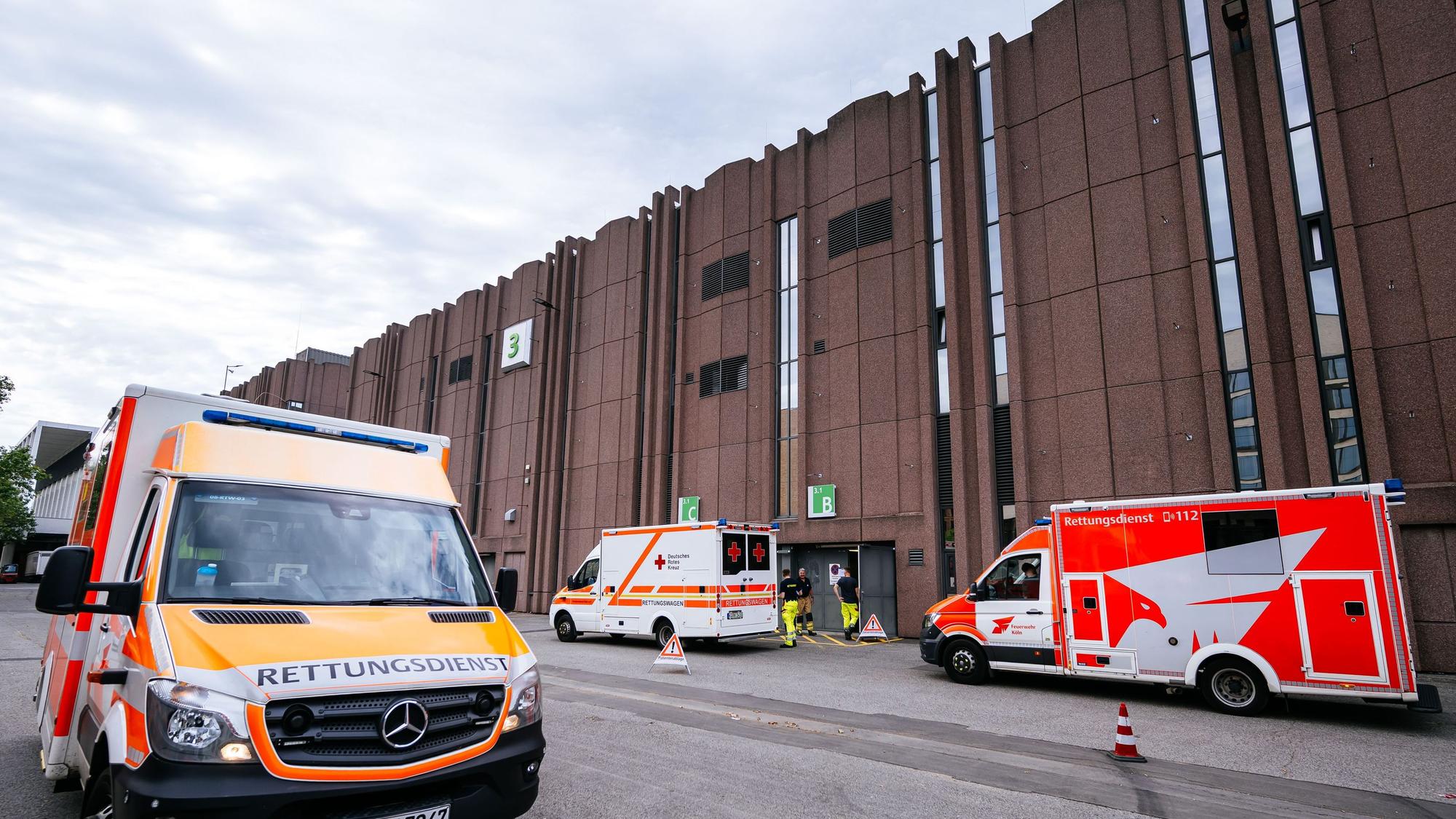 Rettungswagen stehen vor dem Notfallversorgungszentrum in einer Messehalle.