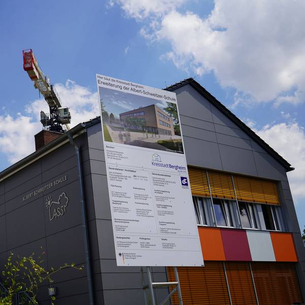 Das Bild zeigt die Albert-Schweitzer-Schule. Im Hintergrund ist ein Baukran zu sehen.