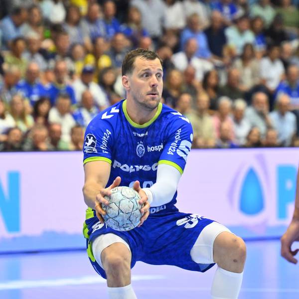 Der Rückraumspieler hält den Ball in beiden Händen.