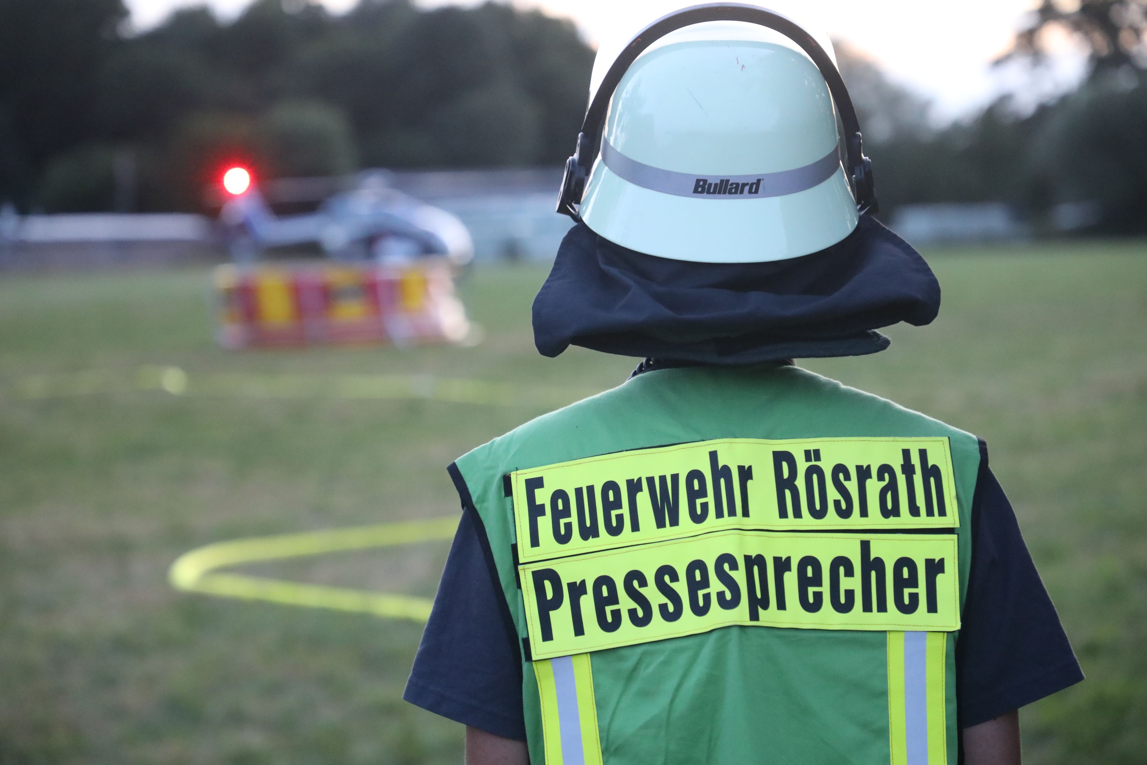 Feuerwehrsprecher Felix Schädlich schaut auf den startenden Hubschrauber.