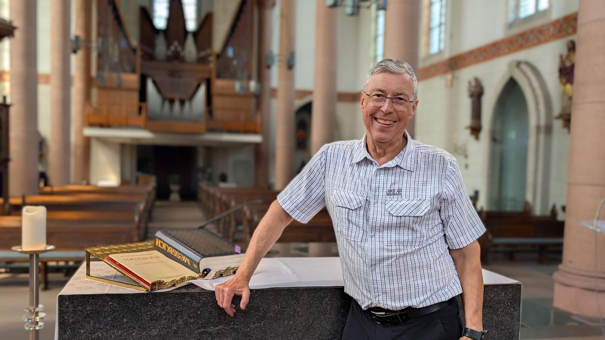 Das Foto zeigt Pfarrer Michael Tillmann am Altar vor leeren Reihen in der Pfarrkirche St. Dionysius in Gleuel.