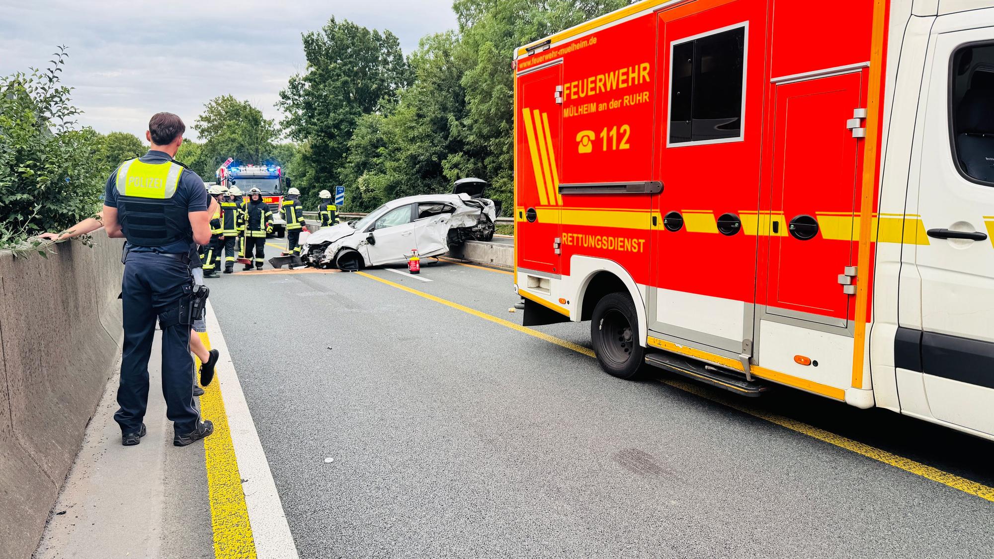 Einsatzkräfte der Polizei und der Feuerwehr am Unfallort auf der A40.
