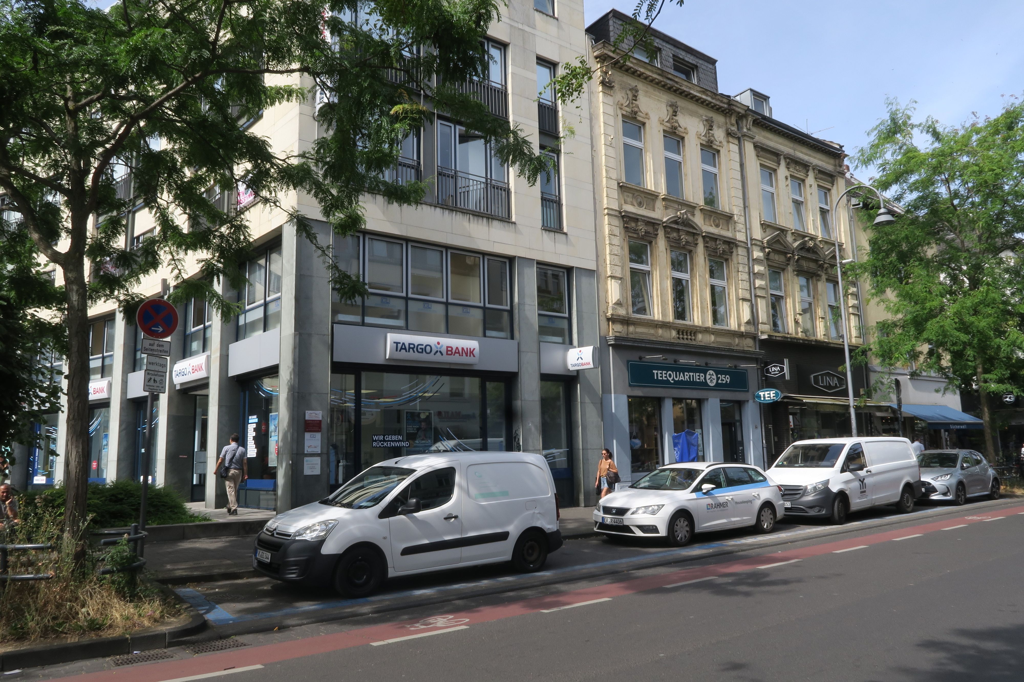 Am Straßenrand parken Liefer- oder Handwerker-Fahrzeuge.