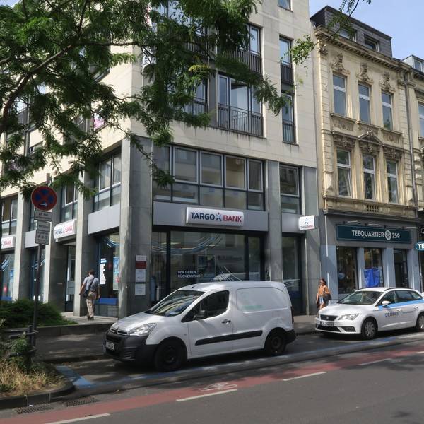 Am Straßenrand parken Liefer- oder Handwerker-Fahrzeuge.