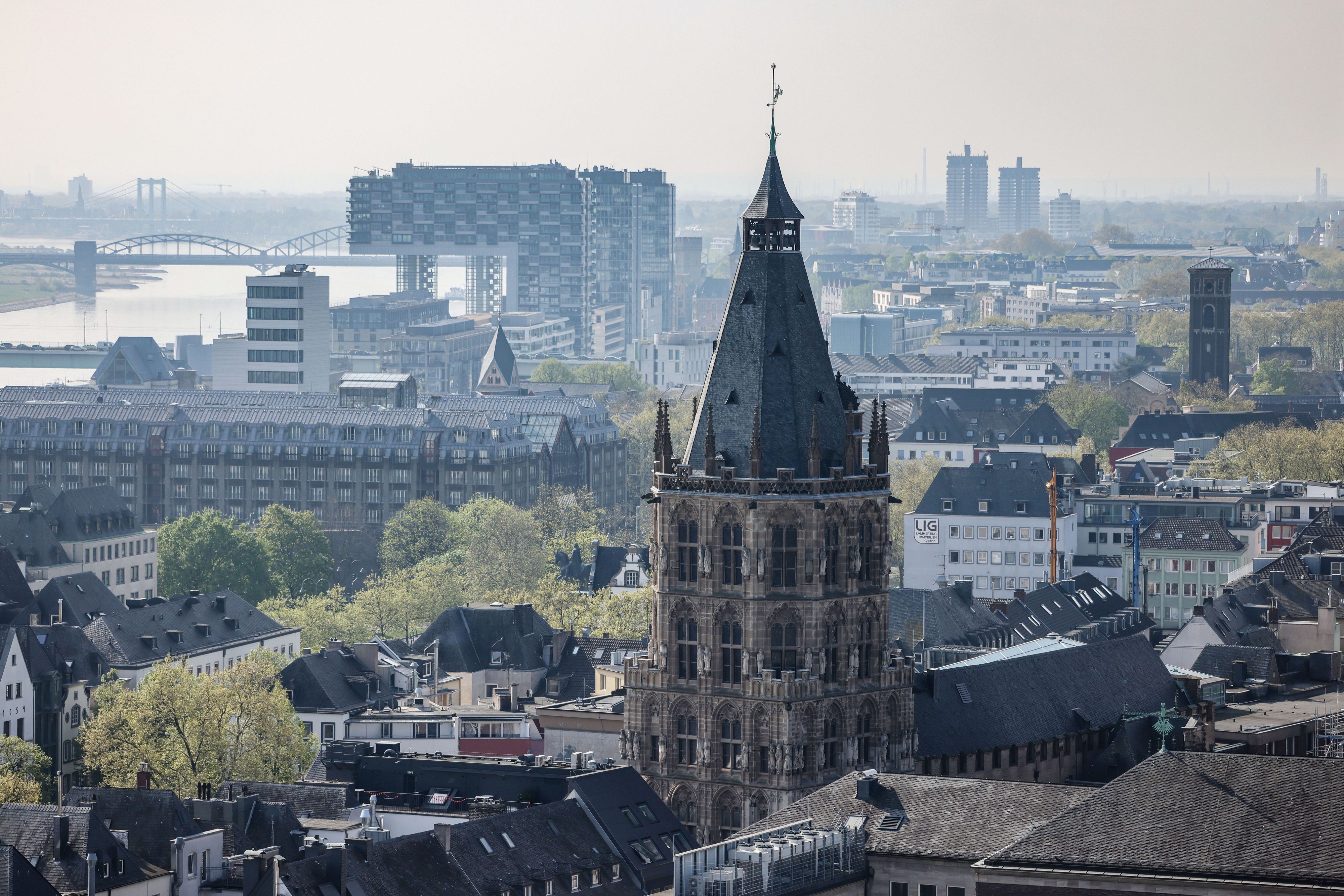 Blick auf den Kölner Rathausturm, im Hintergrund der Rhein und die Kranhäuser