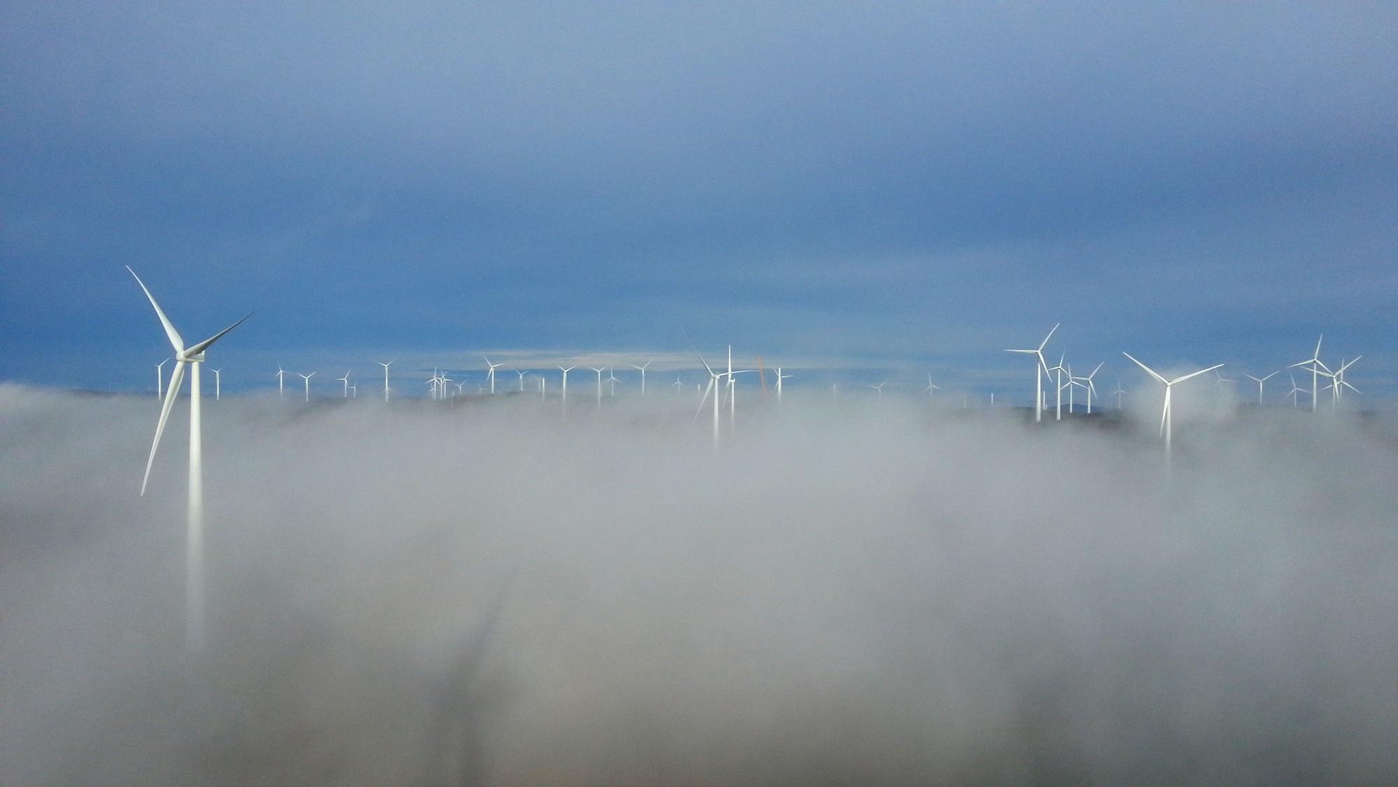 Wind Farm from height over the clouds in Swedish forest