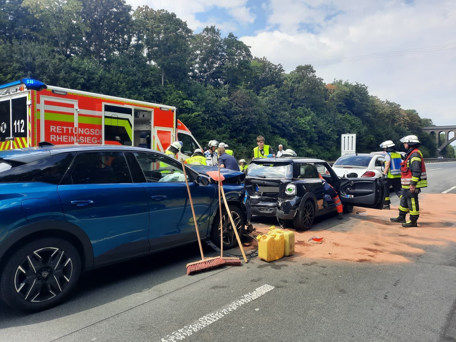 Beschädigte Autos und Einsatzkräfte an einer Unfallstelle.