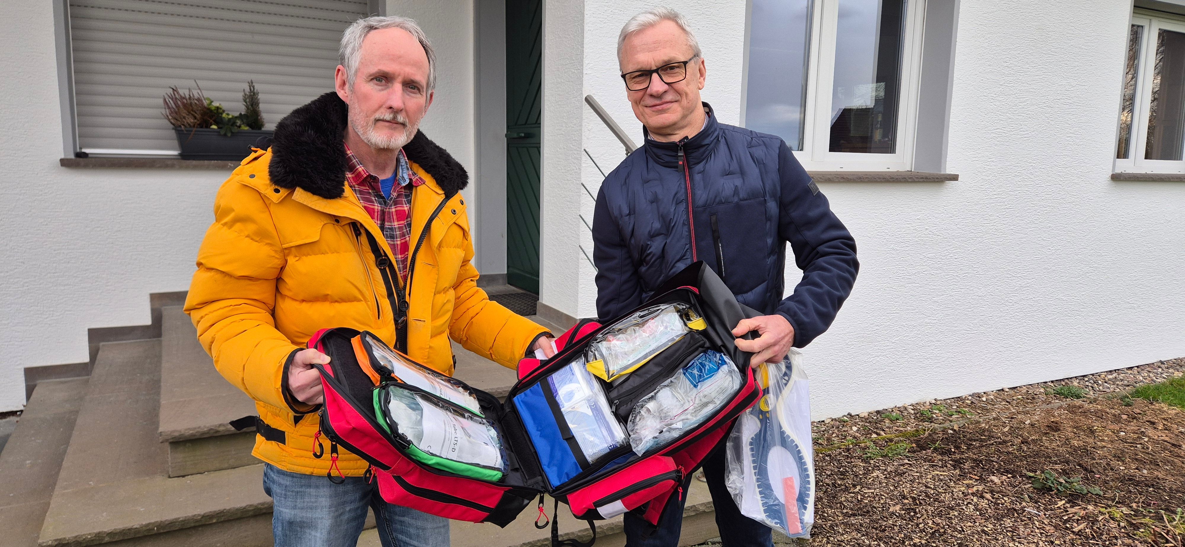 Axel Wild, Vorsitzender der Reservistenkameradschaft Lindlar und Oberstleutnant der Reserve, überreicht Georg Ludwig einen Notfallrucksack.