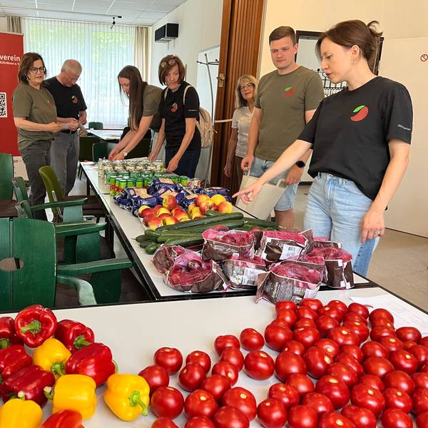 Obstkäppchen-Gründerin Carina Raddatz (r.) und das Unterstützungsteam beim Packen der Lebensmittelbeutel, die einmal im Monat zu bedürftigen Senioren in Porz gebracht werden.