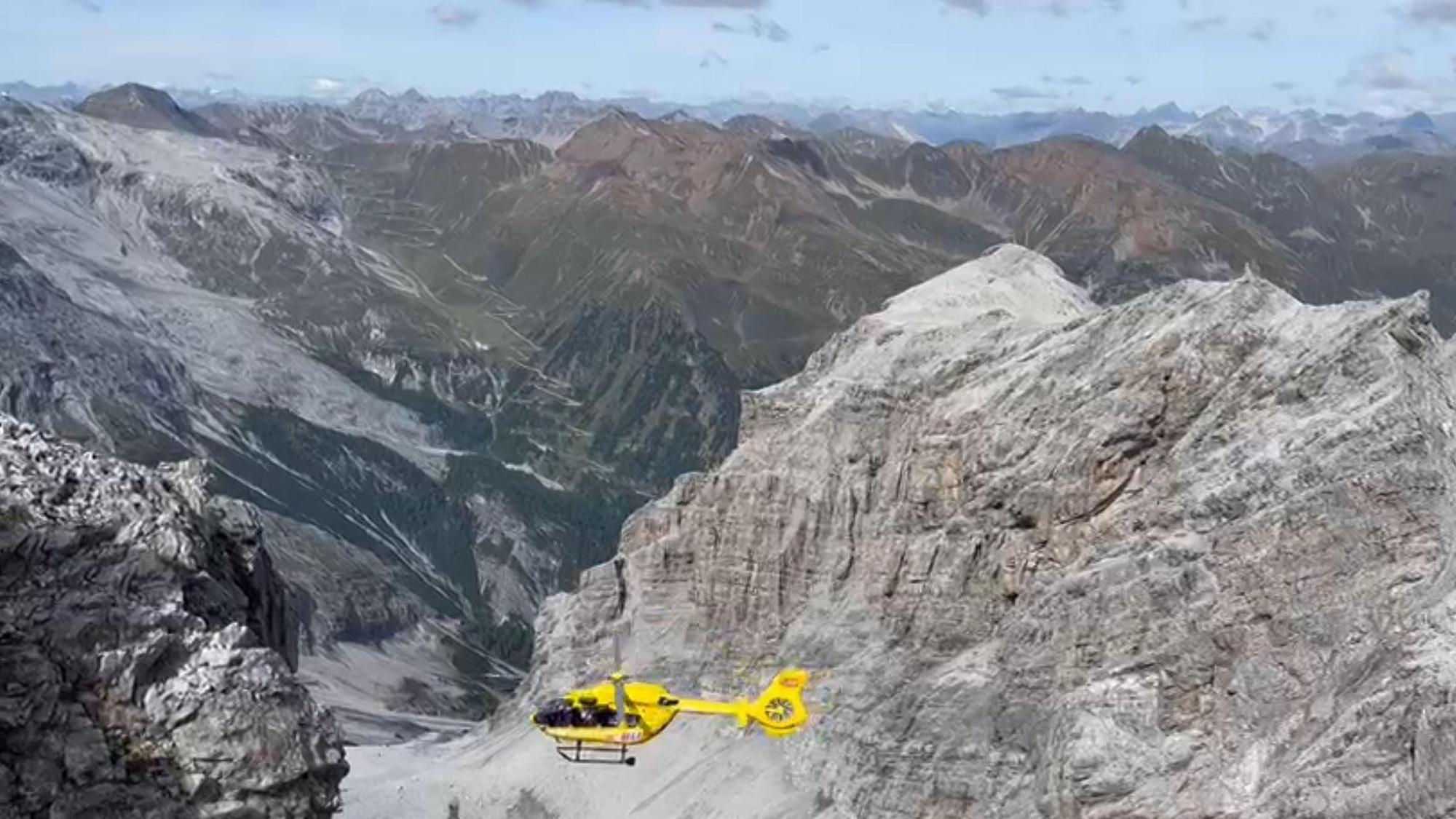Ein Hubschrauber fliegt über ein Gebirge.