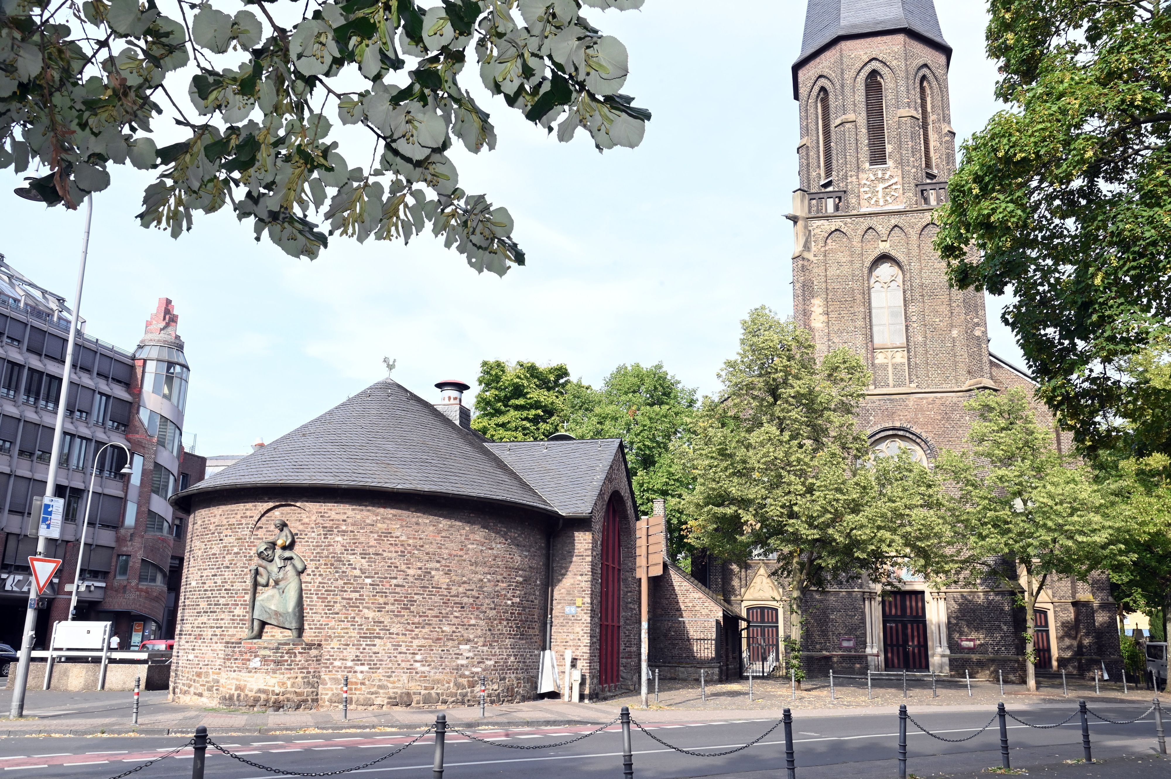 Eine Kirche liegt an einer Straße.