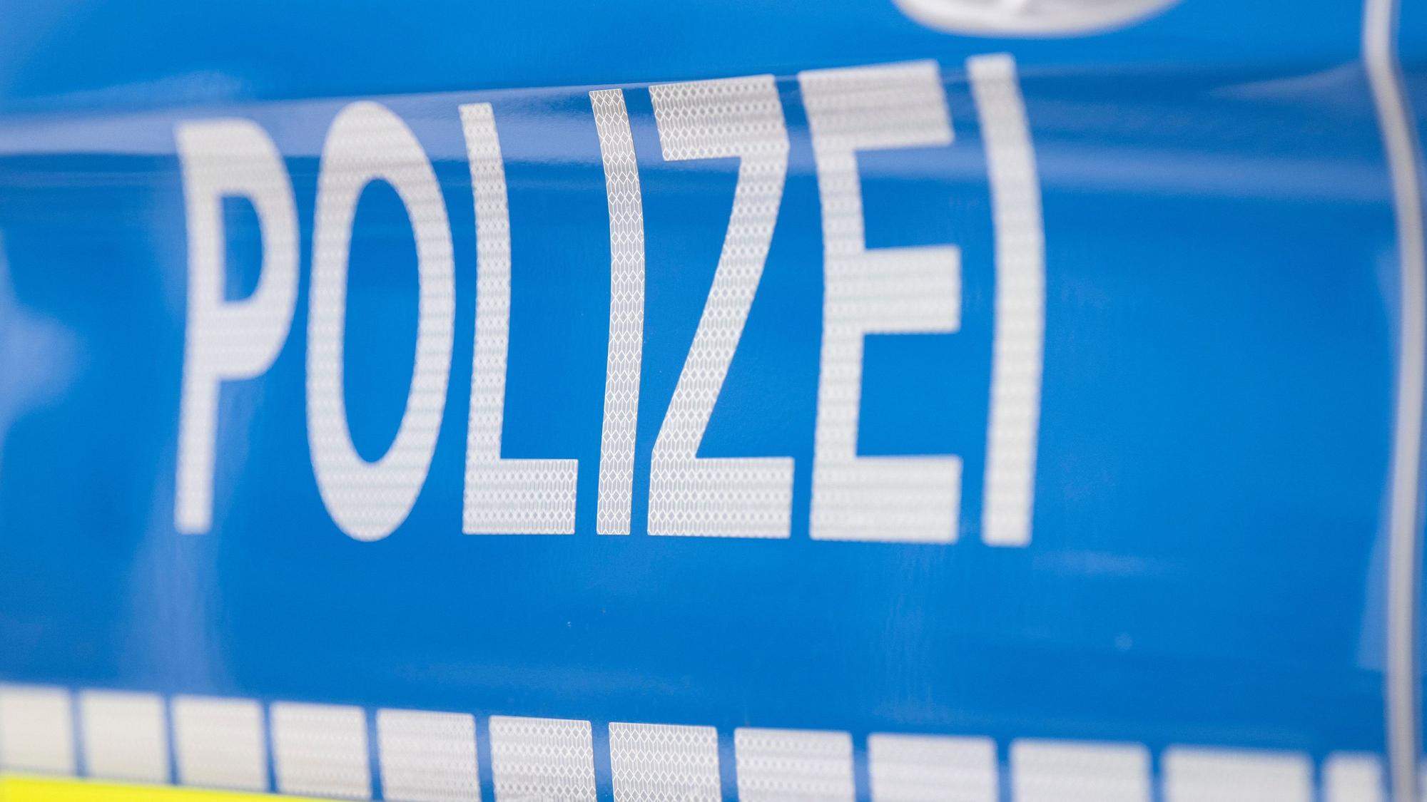 Der Schriftzug „Polizei“ ist auf einem Streifenwagen zu lesen.