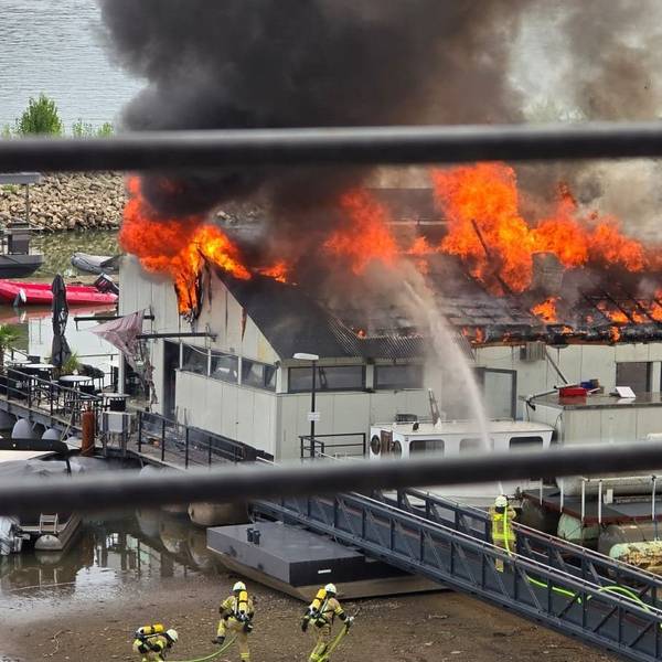 Flammen schlagen aus dem Dach des Sürther Bootshauses.