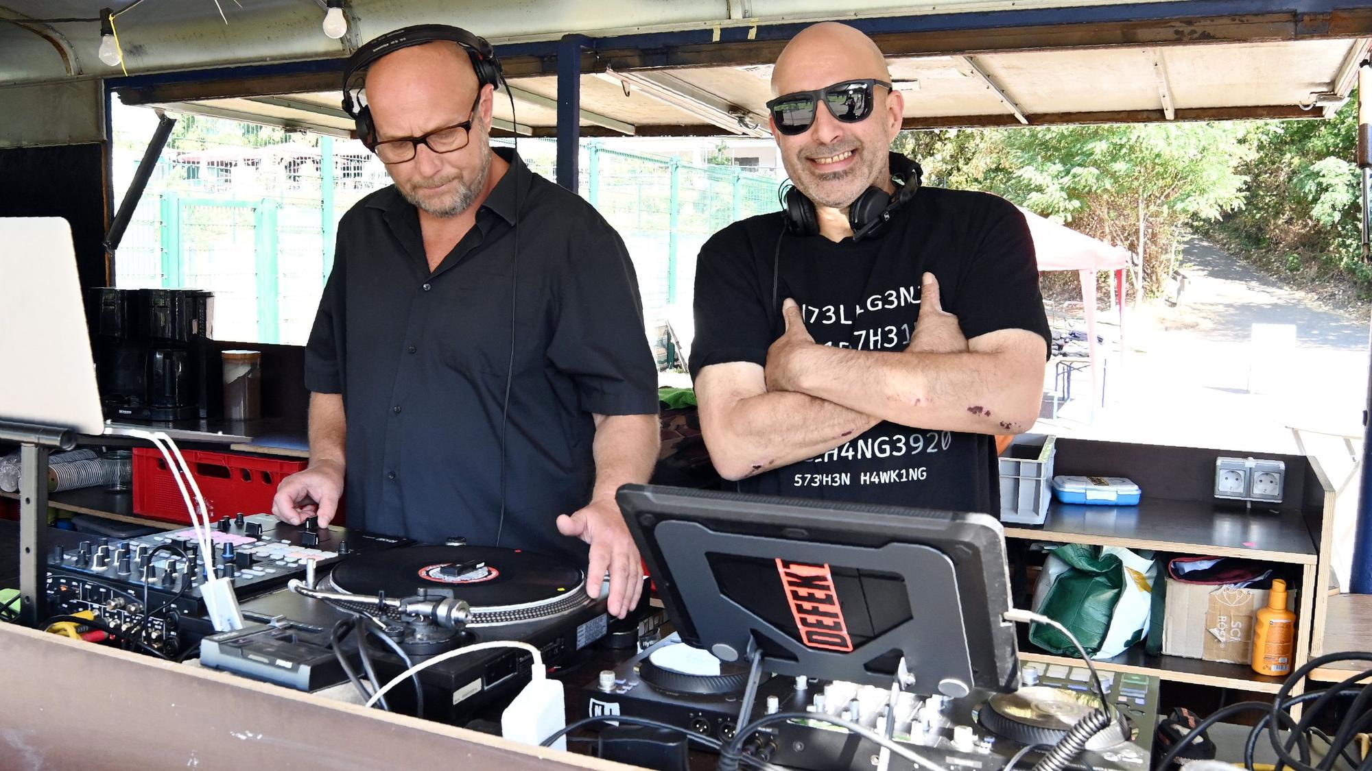 Die DJs Markus (links) und Ponch steuern in ihrem Wagen am Spielfeldrand die Musik.