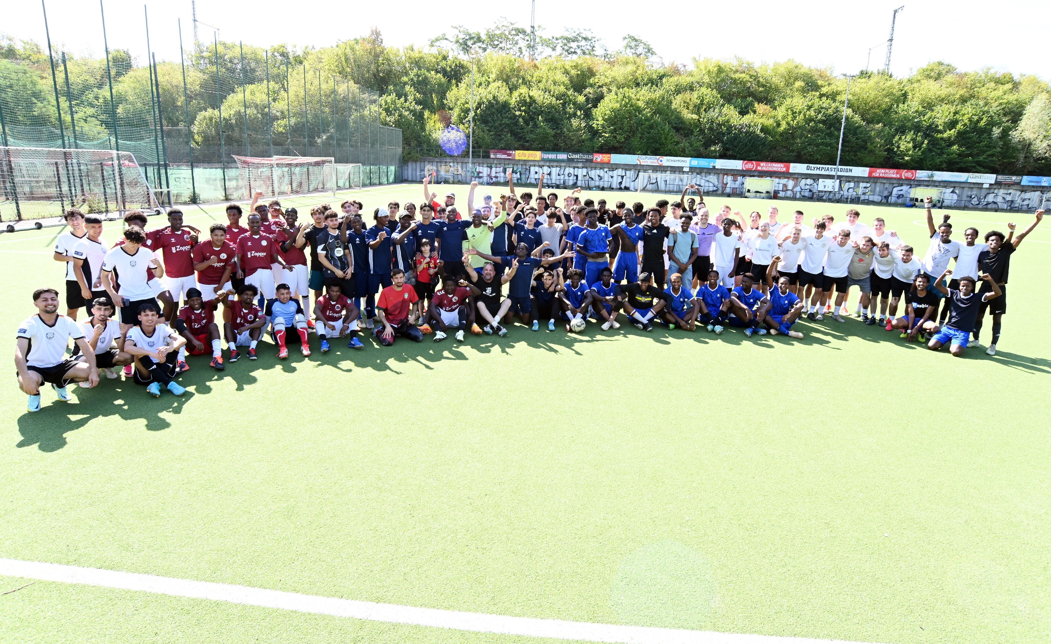 Vor dem Turnier haben sich die Teams mit mehr als 100 Spielern auf dem Rasen versammelt.