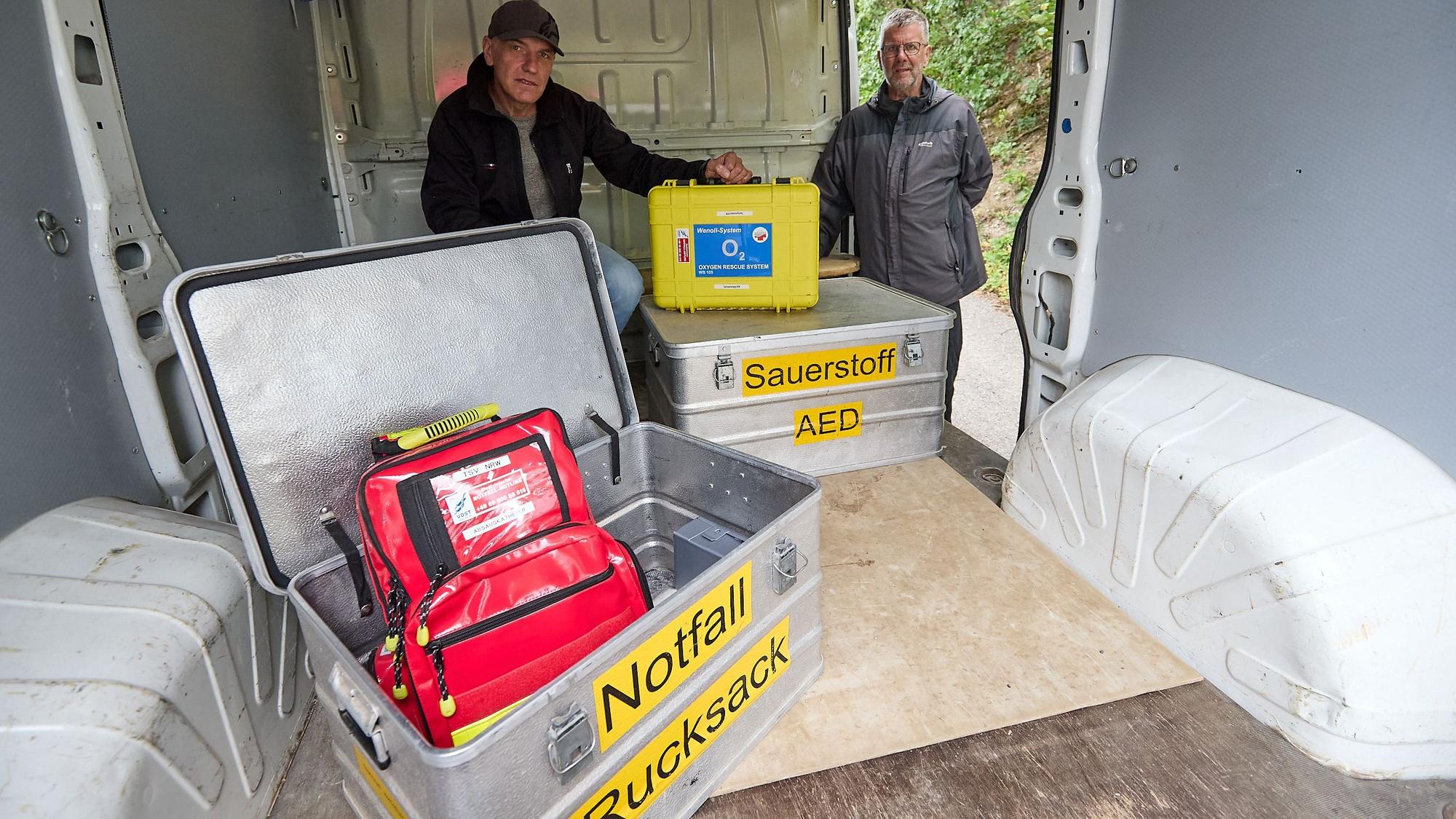 Die Kisten tragen die Aufschriften „Notfall-Rucksack“ und „Sauerstoff/AED“.