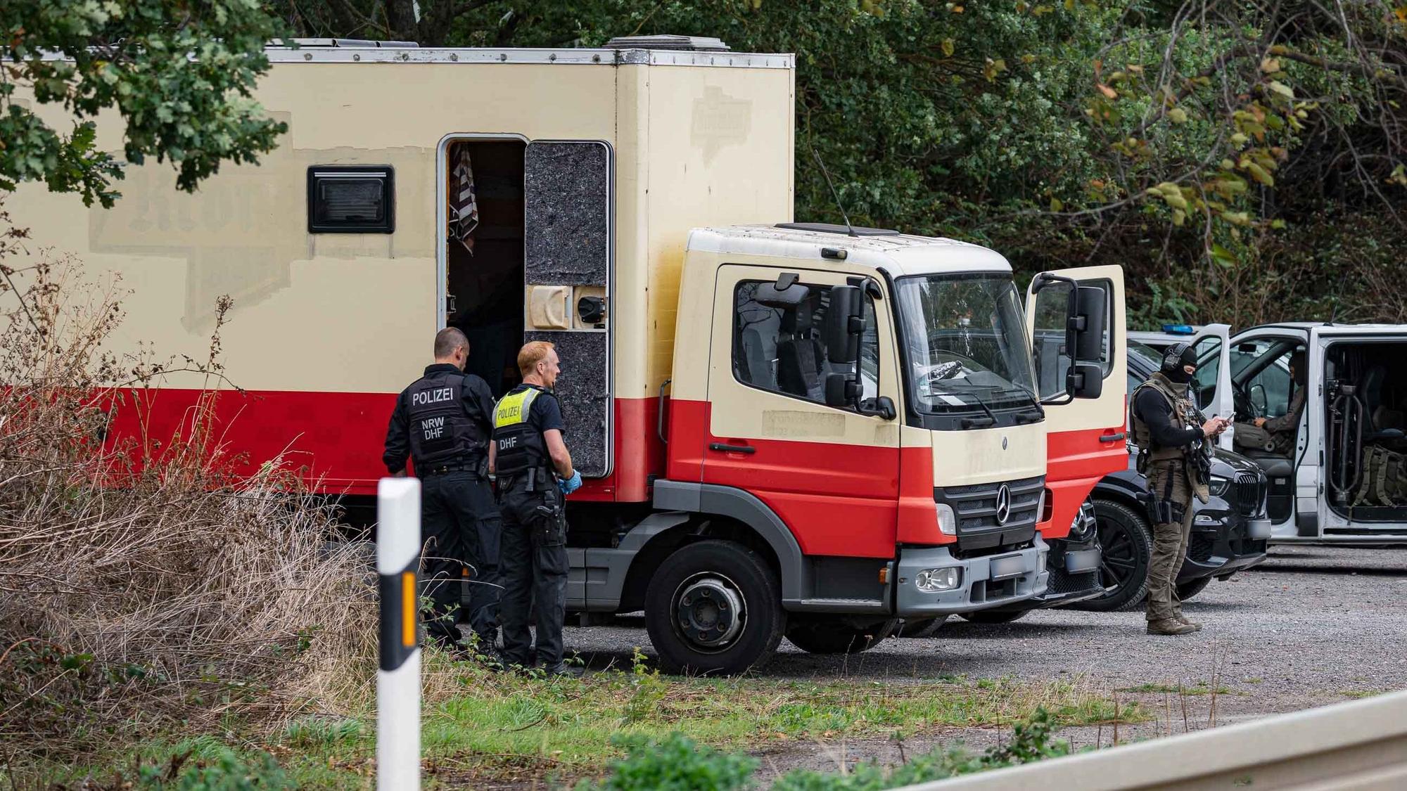 Polizeikräfte sind an einem Lkw im Einsatz.