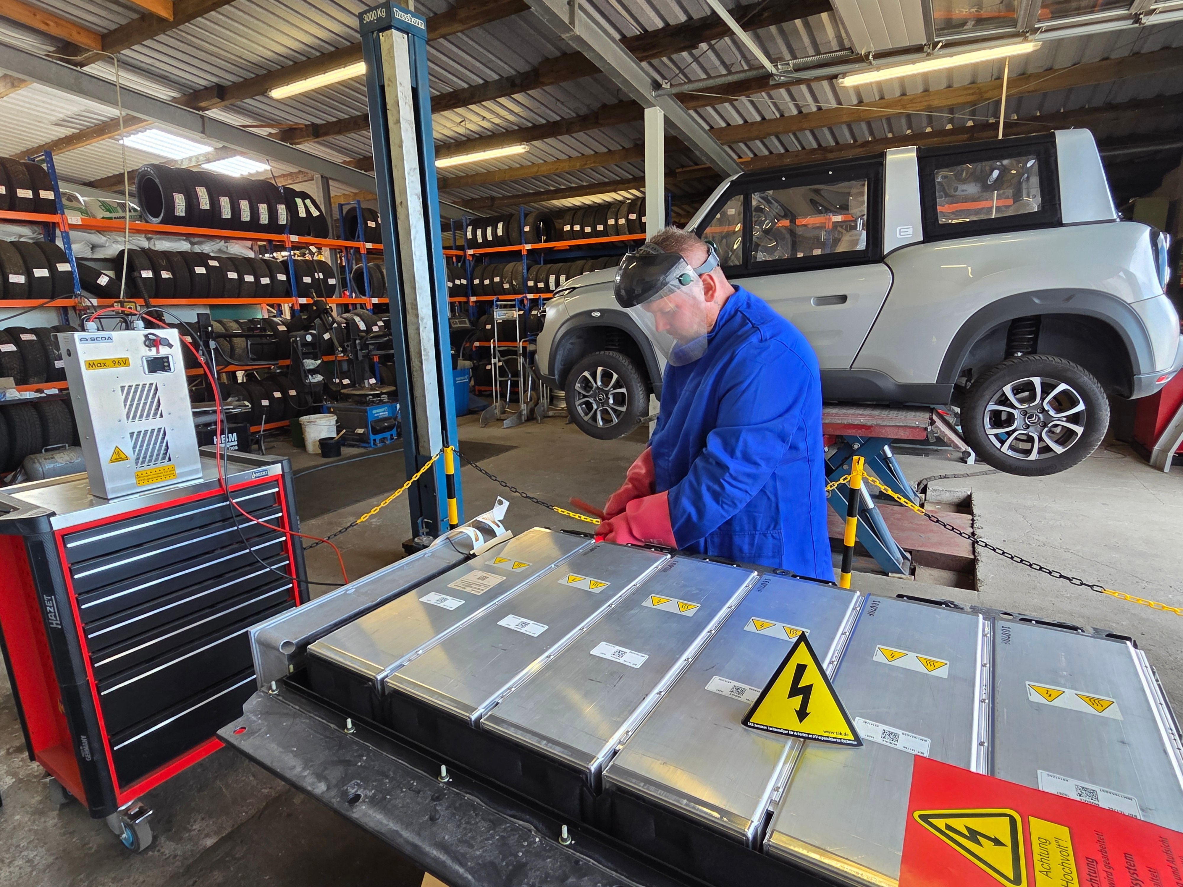 René Fauré, Mitarbeiter der Autoverwertung und des Schrotthandels Noiron von Michael Kappenstein, entlädt die Batterie des Citroën Méhari, der in Waldbröl zerlegt wird. Die Teile werden dann verkauft