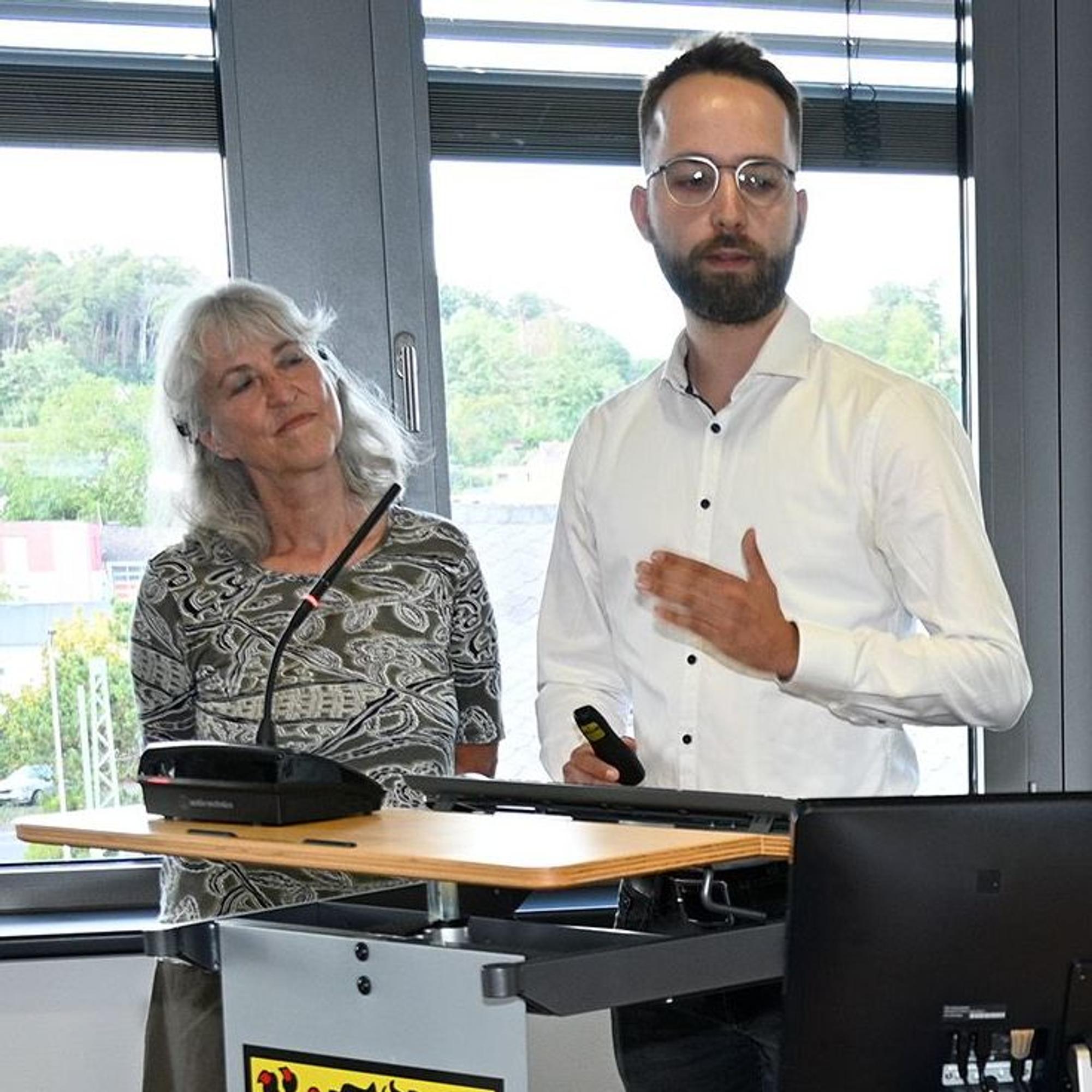 Roswitha und Lukas Latzke stehen nebeneinander an einem Rednerpult.