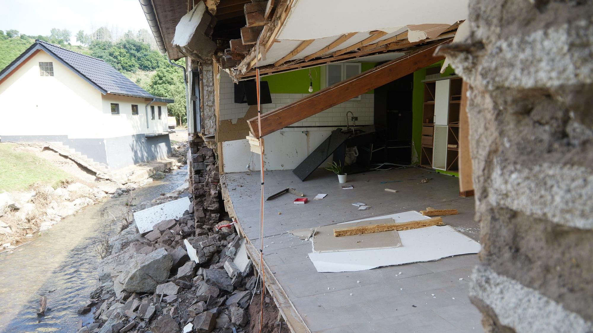 Die Fassade eines Hauses fehlt. Der Manscheider Bach hatte sie bei der Flutkatastrophe 2021 weggerissen.