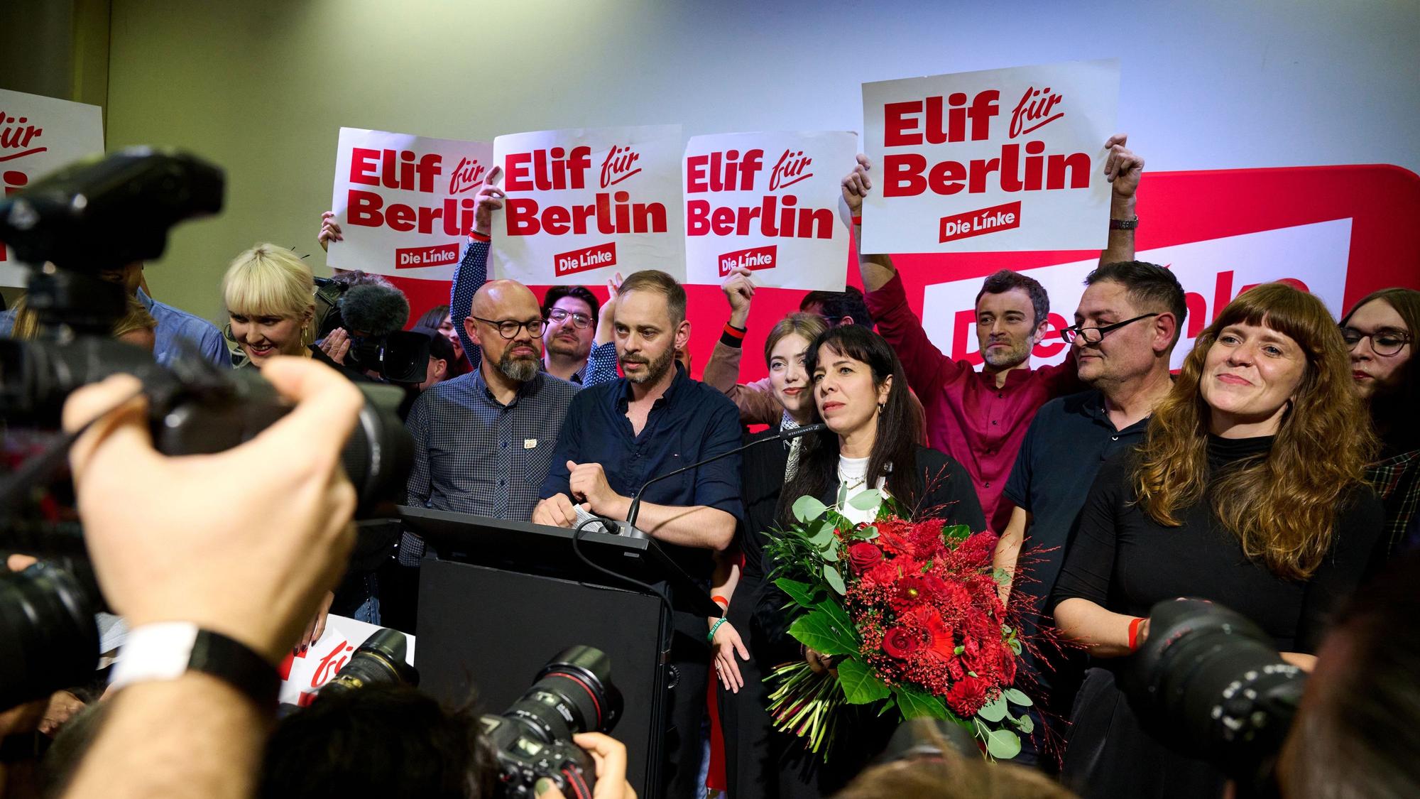 Elif Eralp steht mit einem Blumenstrauß auf dem Podium.