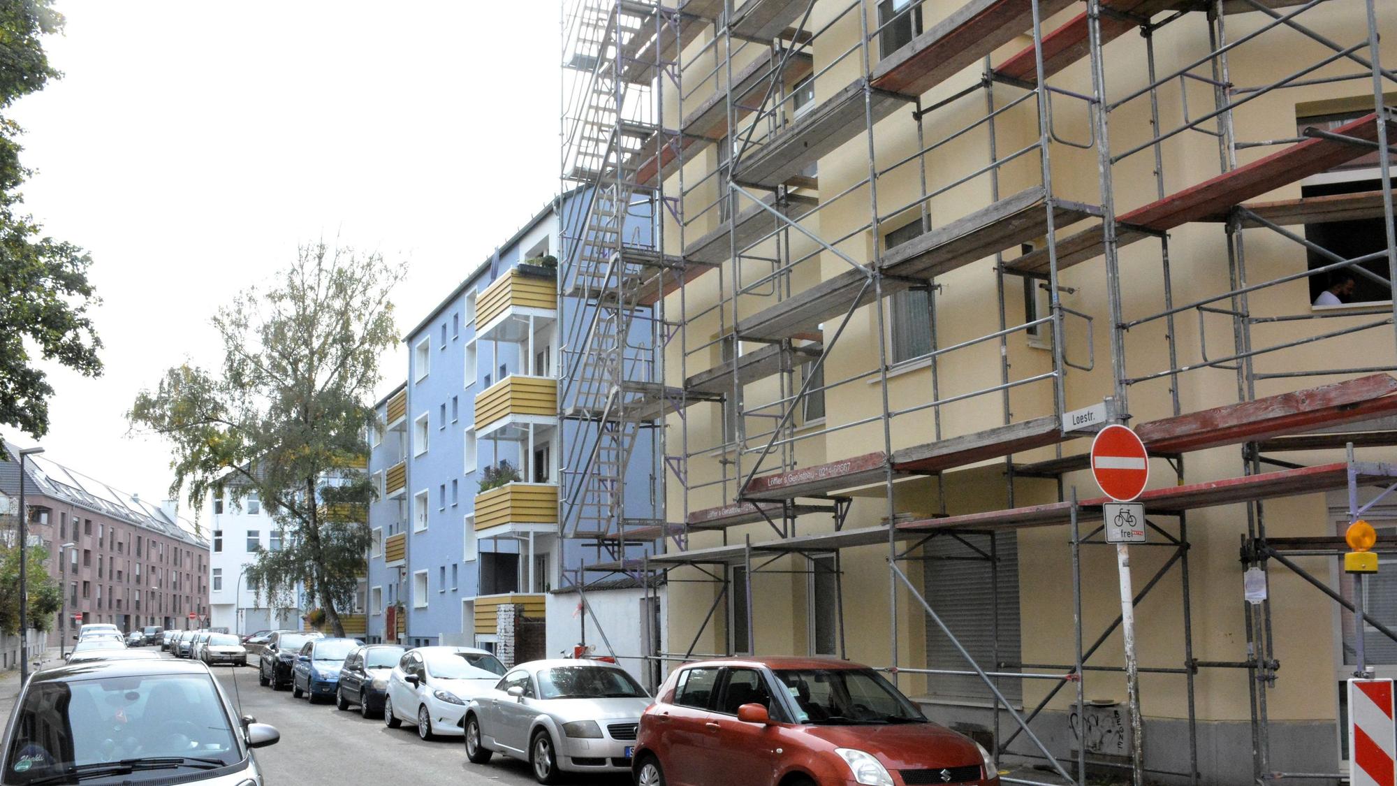 Blick auf ein eingerüstetes Haus. Benachbarte Häuser sind bereits saniert.