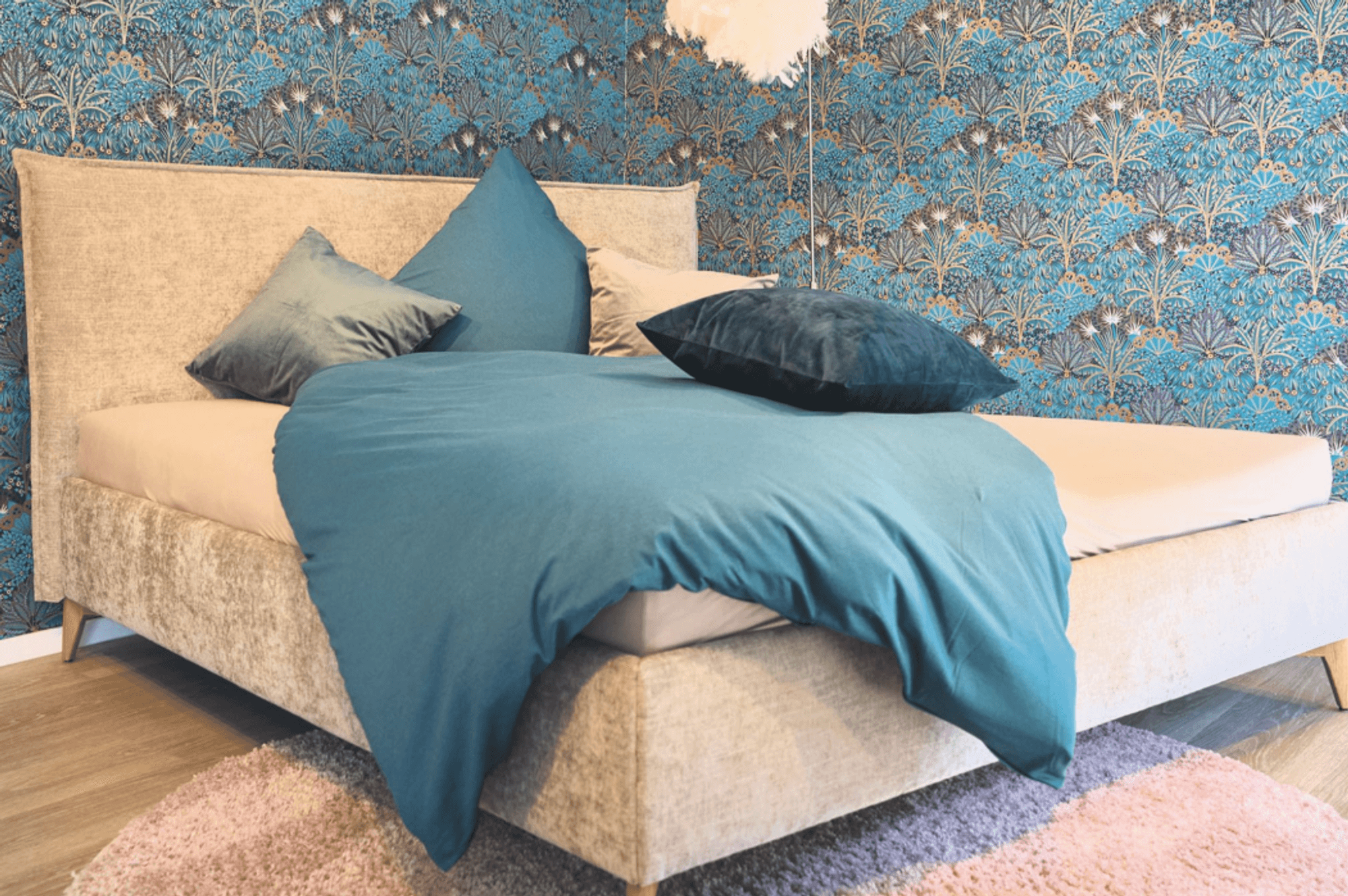 Stilvolles Schlafzimmer mit gepolstertem Boxspringbett und farblich abgestimmten Kissen