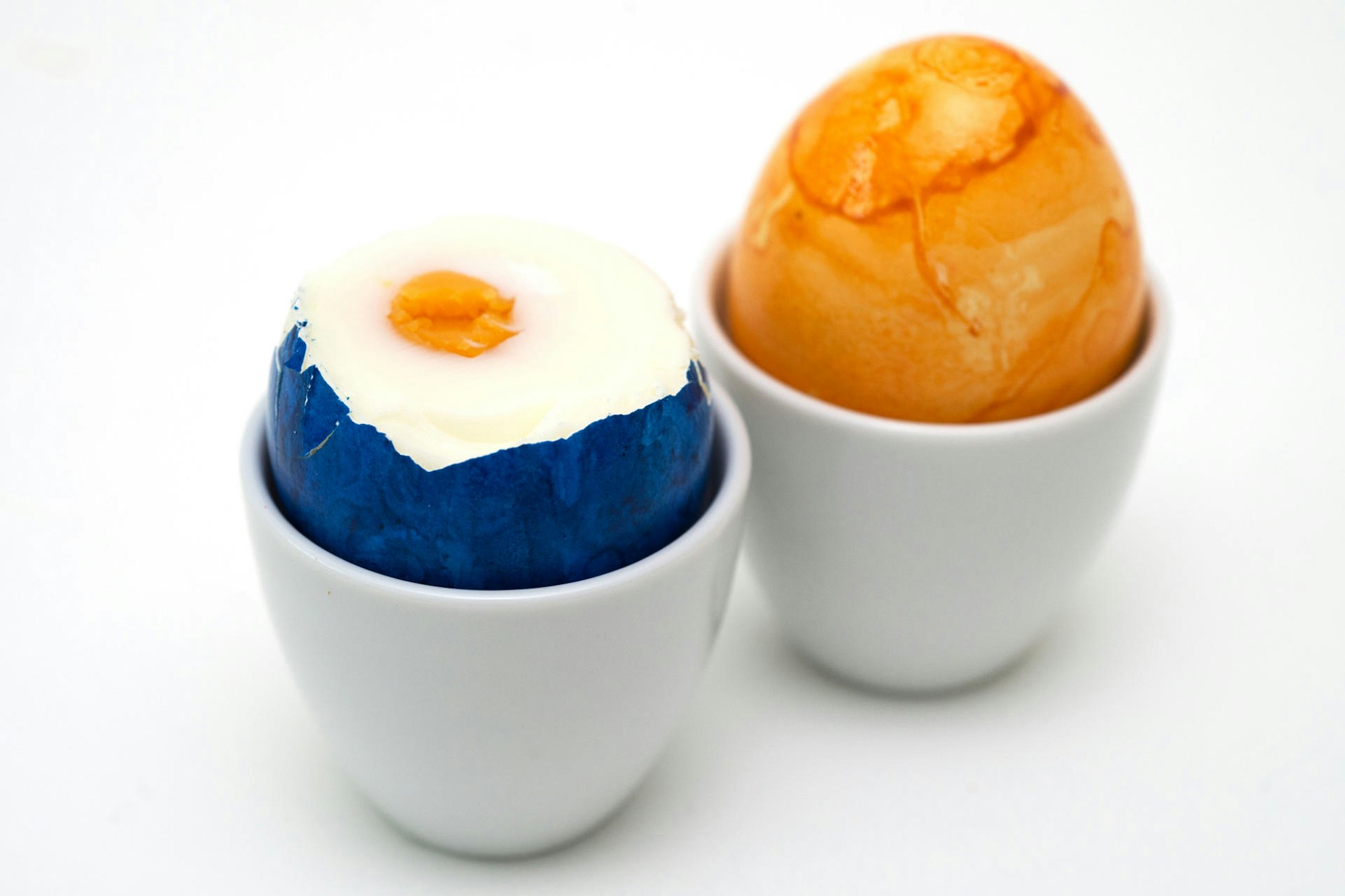 Ein Osterei steckt in einem Eierbecher